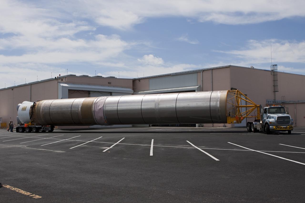 CAPE CANAVERAL, Fla. – The United Launch Alliance Atlas V first stage booster for NASA's Radiation Belt Storm Probes mission arrives at the Atlas Spaceflight Operations Center, or ASOC, at Cape Canaveral Air Force Station in Florida.    The Radiation Belt Storm Probes, or RBSP, mission will help us understand the sun’s influence on Earth and near-Earth space by studying the Earth’s radiation belts on various scales of space and time. For more information, visit http://www.nasa.gov/rbsp. Photo credit: NASA/Jim Grossmann