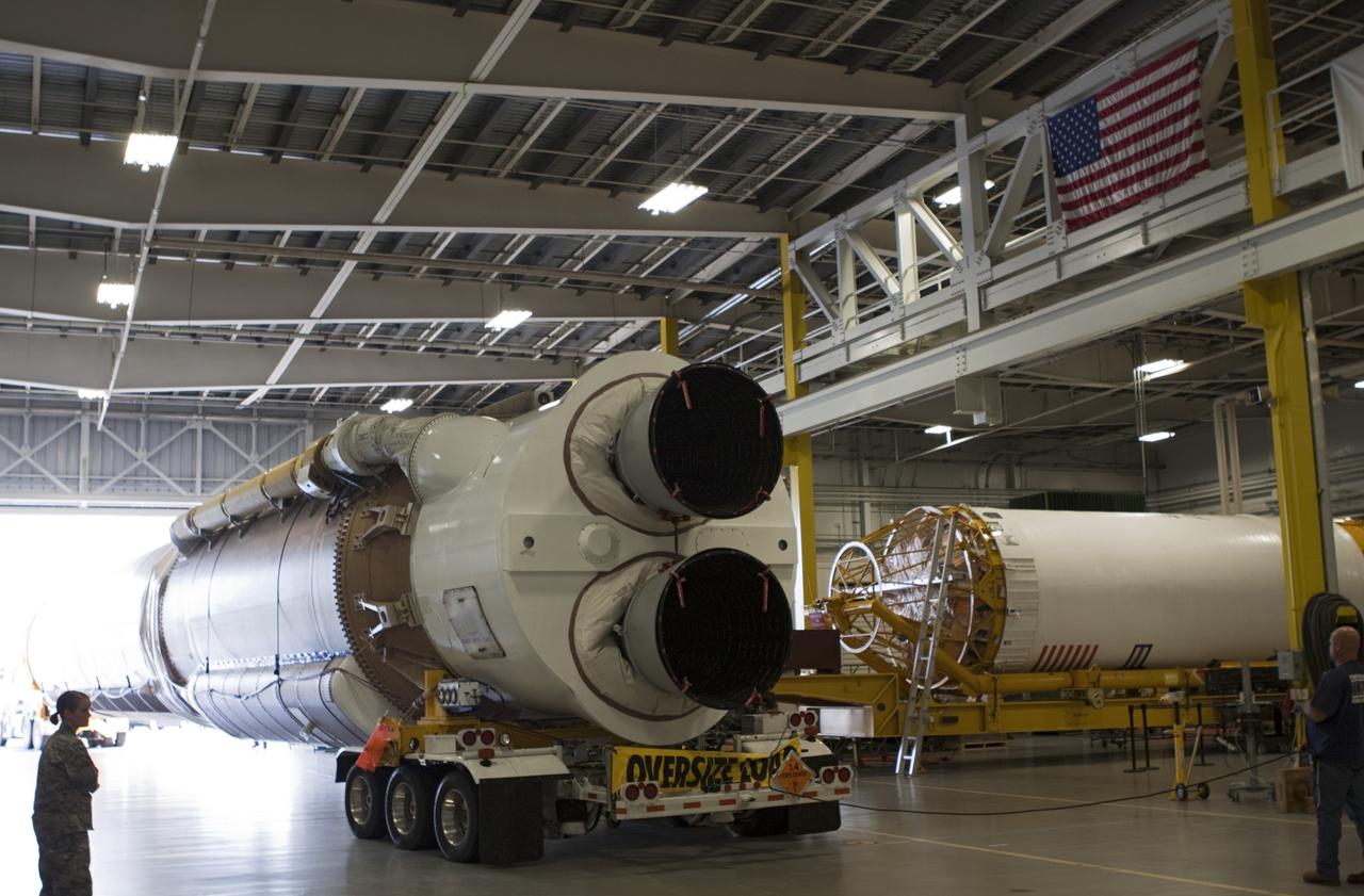 CAPE CANAVERAL, Fla. – The United Launch Alliance Atlas V first stage booster for NASA's Radiation Belt Storm Probes enters the Atlas Spaceflight Operations Center, or ASOC, at Cape Canaveral Air Force Station in Florida. At right is the rocket's Centaur upper stage.    The Radiation Belt Storm Probes, or RBSP, mission will help us understand the sun’s influence on Earth and near-Earth space by studying the Earth’s radiation belts on various scales of space and time. For more information, visit http://www.nasa.gov/rbsp. Photo credit: NASA/Jim Grossmann