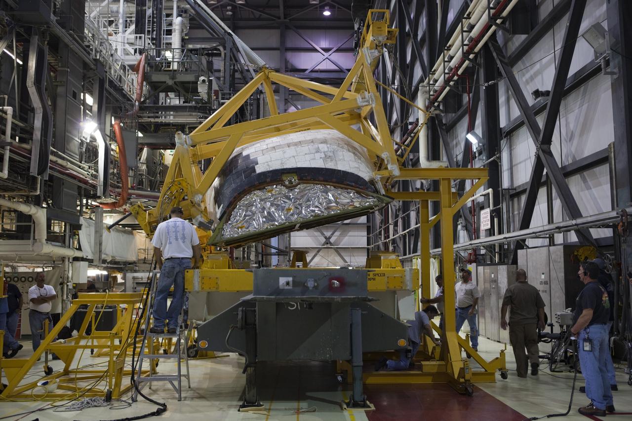 CAPE CANAVERAL, Fla. – Inside Orbiter Processing Facility-1 at NASA’s Kennedy Space Center in Florida, United Space Alliance technicians monitor the progress as a large crane begins to lift the right orbital maneuvering system, or OMS, pod for installation on space shuttle Atlantis. It is the last time an OMS pod will be installed on Atlantis. The OMS provided the shuttle with thrust for orbit insertion, rendezvous and deorbit, and could provide up to 1,000 pounds of propellant to the aft reaction control system.    The OMS is housed in two independent pods located on each side of the shuttle’s aft fuselage. Each pod contains one OMS engine and the hardware needed to pressurize, store and distribute the propellants to perform the velocity maneuvers. Atlantis’ OMS pods were removed and sent to the test facility at White Sands Space Harbor in New Mexico to be cleaned of residual toxic propellant. The work is part of the Space Shuttle Program’s transition and retirement processing of the space shuttle fleet. A groundbreaking was held Jan. 18 for Atlantis’ future home, a 65,000-square-foot exhibit hall in Shuttle Plaza at the Kennedy Space Center Visitor Complex. Atlantis is scheduled to roll over to the visitor complex in November in preparation for the exhibit’s grand opening in July 2013. For more information, visit http://www.nasa.gov/transition. Photo credit: NASA/Dimitri Gerondidakis