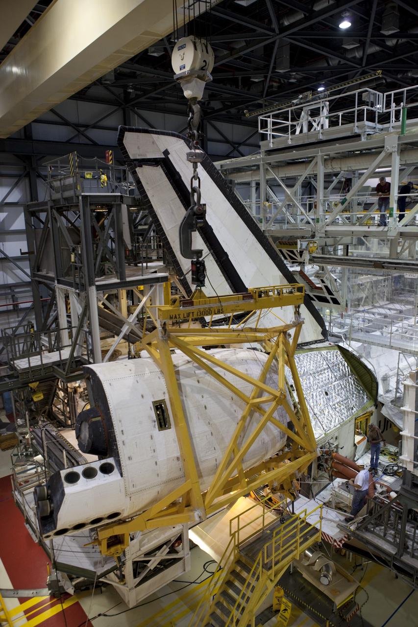 CAPE CANAVERAL, Fla. – Inside Orbiter Processing Facility-1 at NASA’s Kennedy Space Center in Florida, a large crane moves the right orbital maneuvering system, or OMS, pod closer to space shuttle Atlantis. It is the last time an OMS pod will be installed on Atlantis. The OMS provided the shuttle with thrust for orbit insertion, rendezvous and deorbit, and could provide up to 1,000 pounds of propellant to the aft reaction control system.    The OMS is housed in two independent pods located on each side of the shuttle’s aft fuselage. Each pod contains one OMS engine and the hardware needed to pressurize, store and distribute the propellants to perform the velocity maneuvers. Atlantis’ OMS pods were removed and sent to the test facility at White Sands Space Harbor in New Mexico to be cleaned of residual toxic propellant. The work is part of the Space Shuttle Program’s transition and retirement processing of the space shuttle fleet. A groundbreaking was held Jan. 18 for Atlantis’ future home, a 65,000-square-foot exhibit hall in Shuttle Plaza at the Kennedy Space Center Visitor Complex. Atlantis is scheduled to roll over to the visitor complex in November in preparation for the exhibit’s grand opening in July 2013. For more information, visit http://www.nasa.gov/transition. Photo credit: NASA/Dimitri Gerondidakis