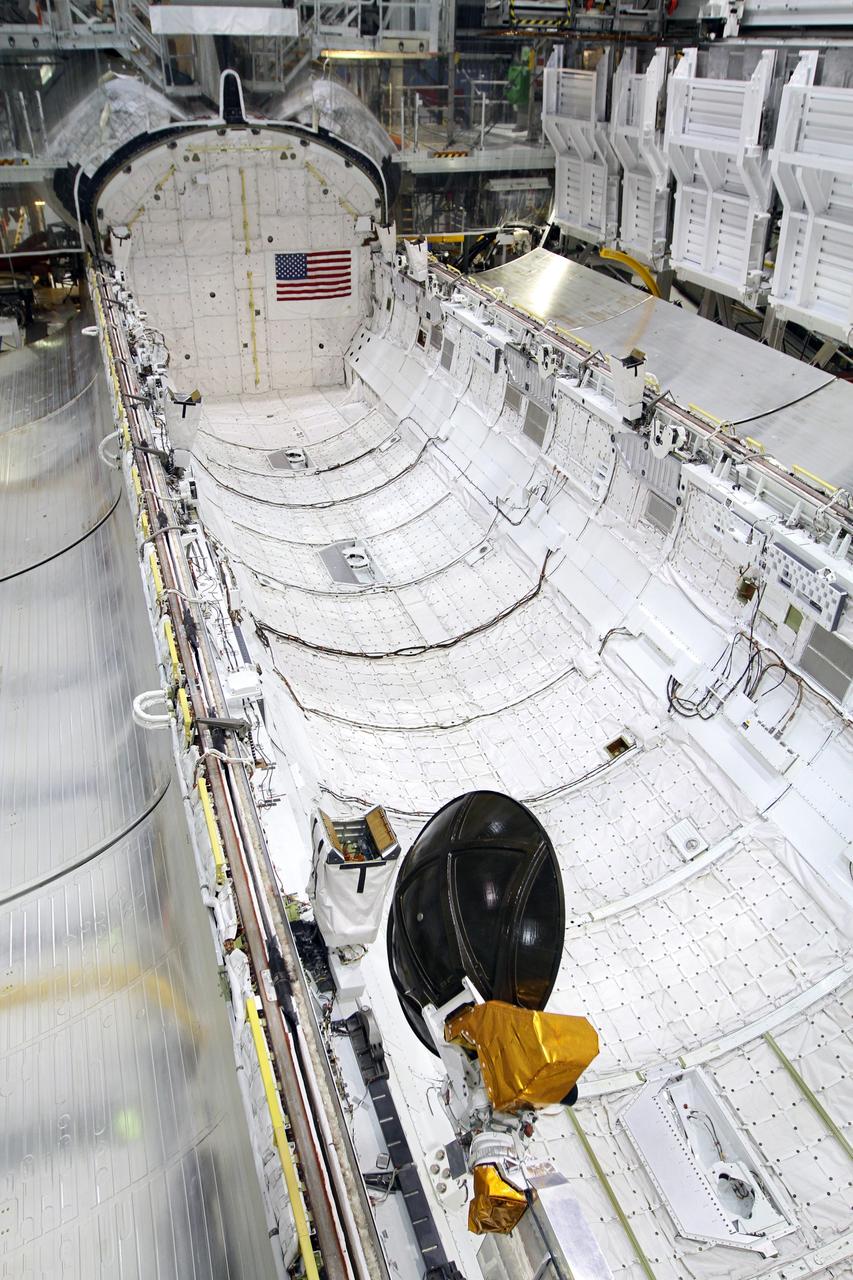 CAPE CANAVERAL, Fla. – Inside Orbiter Processing Facility-2 at NASA’s Kennedy Space Center in Florida, the payload bay doors on space shuttle Endeavour are in the open position. United Space Alliance technicians are preparing to close the doors for the final time. The work is part of Transition and Retirement of the remaining space shuttles, Endeavour and Atlantis. Endeavour is being prepared for public display at the California Science Center in Los Angeles. Its ferry flight to California is targeted for mid-September. Endeavour was the last space shuttle added to NASA’s orbiter fleet. Over the course of its 19-year career, Endeavour spent 299 days in space during 25 missions. For more information, visit http://www.nasa.gov/shuttle. Photo credit: NASA/Kim Shiflett