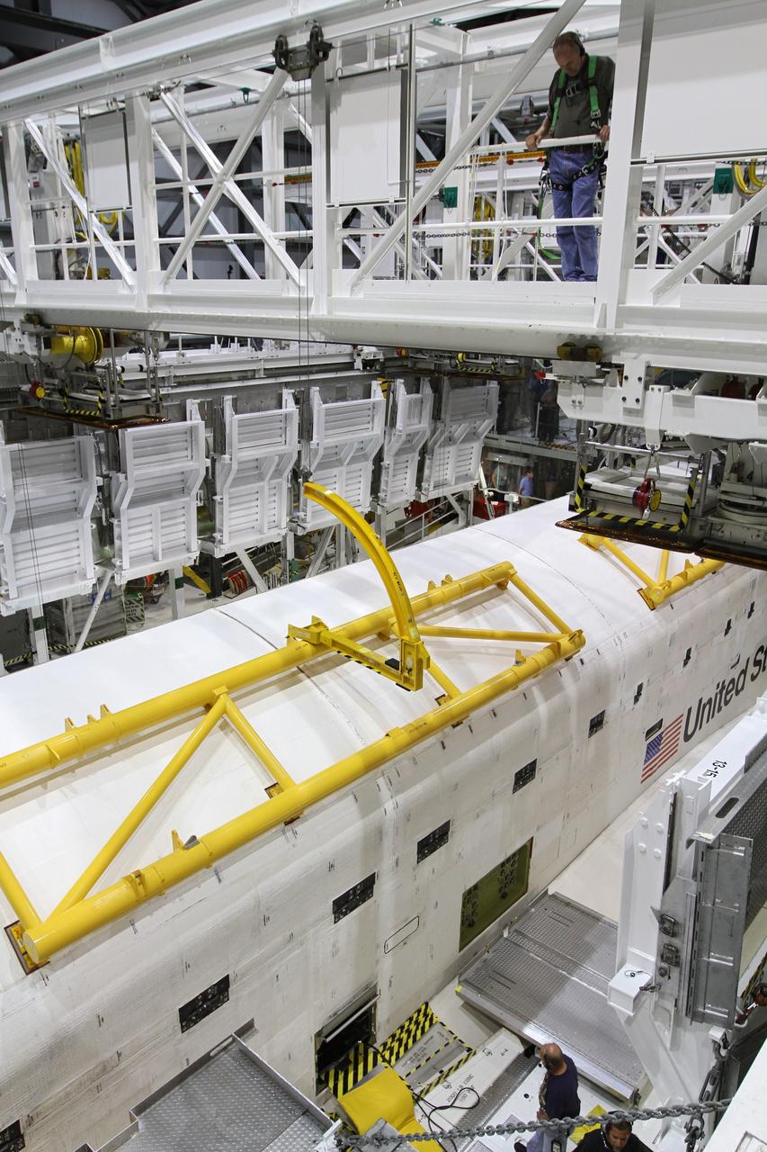 CAPE CANAVERAL, Fla. – Inside Orbiter Processing Facility-2 at NASA’s Kennedy Space Center in Florida, one of space shuttle Endeavour’s payload bay doors is closed as a United Space Alliance technician monitors the progress of the second door’s closure. Endeavour’s payload bay doors are being closed for the final time. The work is part of Transition and Retirement of the remaining space shuttles, Endeavour and Atlantis. Endeavour is being prepared for public display at the California Science Center in Los Angeles. Its ferry flight to California is targeted for mid-September. Endeavour was the last space shuttle added to NASA’s orbiter fleet. Over the course of its 19-year career, Endeavour spent 299 days in space during 25 missions. For more information, visit http://www.nasa.gov/shuttle. Photo credit: NASA/Kim Shiflett