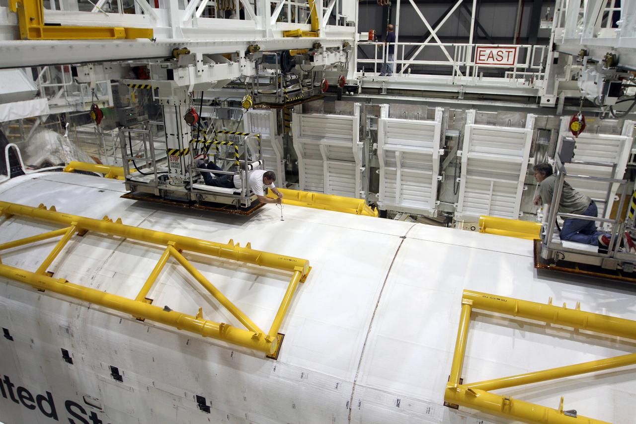 CAPE CANAVERAL, Fla. – Inside Orbiter Processing Facility-2 at NASA’s Kennedy Space Center in Florida, United Space Alliance technicians inspect space shuttle Endeavour’s payload bay doors after they were closed for the final time. The work is part of Transition and Retirement of the remaining space shuttles, Endeavour and Atlantis. Endeavour is being prepared for public display at the California Science Center in Los Angeles. Its ferry flight to California is targeted for mid-September. Endeavour was the last space shuttle added to NASA’s orbiter fleet. Over the course of its 19-year career, Endeavour spent 299 days in space during 25 missions. For more information, visit http://www.nasa.gov/shuttle. Photo credit: NASA/Kim Shiflett