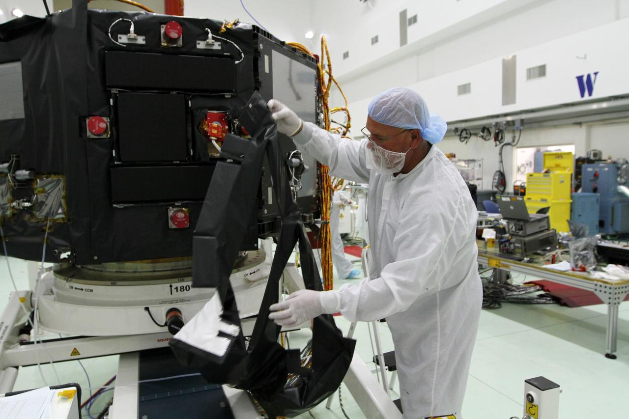 CAPE CANAVERAL, Fla. – Inside the Astrotech payload processing facility near NASA’s Kennedy Space Center in Florida, a technician installs protective thermal blankets around the Radiation Belt Storm Probes, or RBSP, spacecraft A. NASA’s RBSP mission will help us understand the sun’s influence on Earth and near-Earth space by studying the Earth’s radiation belts on various scales of space and time. RBSP will begin its mission of exploration of Earth’s Van Allen radiation belts and the extremes of space weather after its launch aboard a United Launch Alliance Atlas V rocket. Launch is targeted for Aug. 23. For more information, visit http://www.nasa.gov/rbsp. Photo credit: NASA/Kim Shiflett