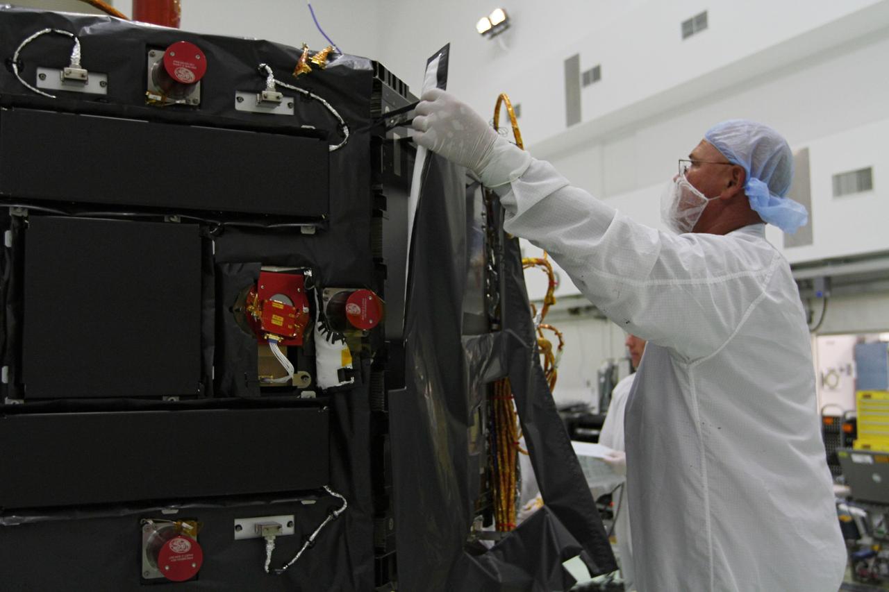 CAPE CANAVERAL, Fla. – Inside the Astrotech payload processing facility near NASA’s Kennedy Space Center in Florida, a technician installs protective thermal blankets around the Radiation Belt Storm Probes, or RBSP, spacecraft A. NASA’s RBSP mission will help us understand the sun’s influence on Earth and near-Earth space by studying the Earth’s radiation belts on various scales of space and time. RBSP will begin its mission of exploration of Earth’s Van Allen radiation belts and the extremes of space weather after its launch aboard a United Launch Alliance Atlas V rocket. Launch is targeted for Aug. 23. For more information, visit http://www.nasa.gov/rbsp. Photo credit: NASA/Kim Shiflett