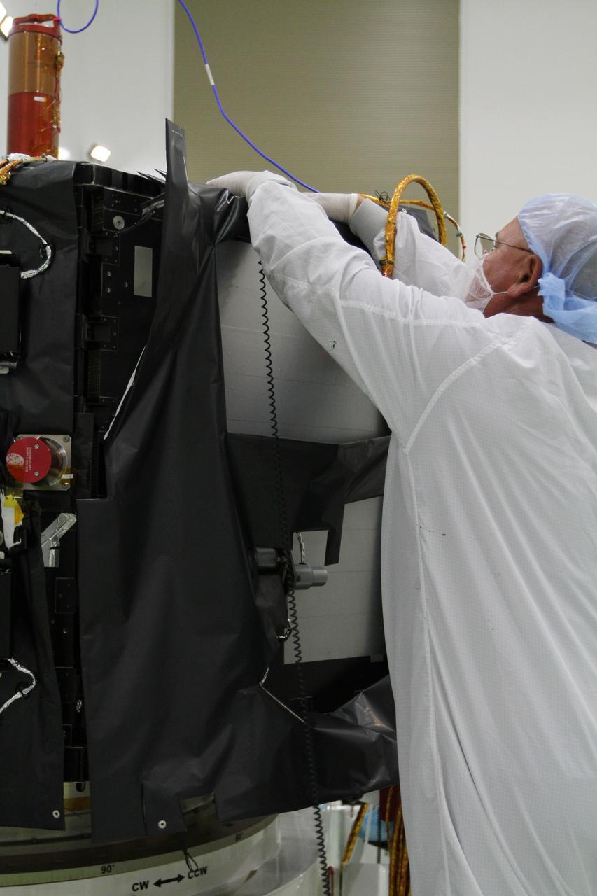 CAPE CANAVERAL, Fla. – Inside the Astrotech payload processing facility near NASA’s Kennedy Space Center in Florida, a technician installs protective thermal blankets around the Radiation Belt Storm Probes, or RBSP, spacecraft A. NASA’s RBSP mission will help us understand the sun’s influence on Earth and near-Earth space by studying the Earth’s radiation belts on various scales of space and time. RBSP will begin its mission of exploration of Earth’s Van Allen radiation belts and the extremes of space weather after its launch aboard a United Launch Alliance Atlas V rocket. Launch is targeted for Aug. 23. For more information, visit http://www.nasa.gov/rbsp. Photo credit: NASA/Kim Shiflett