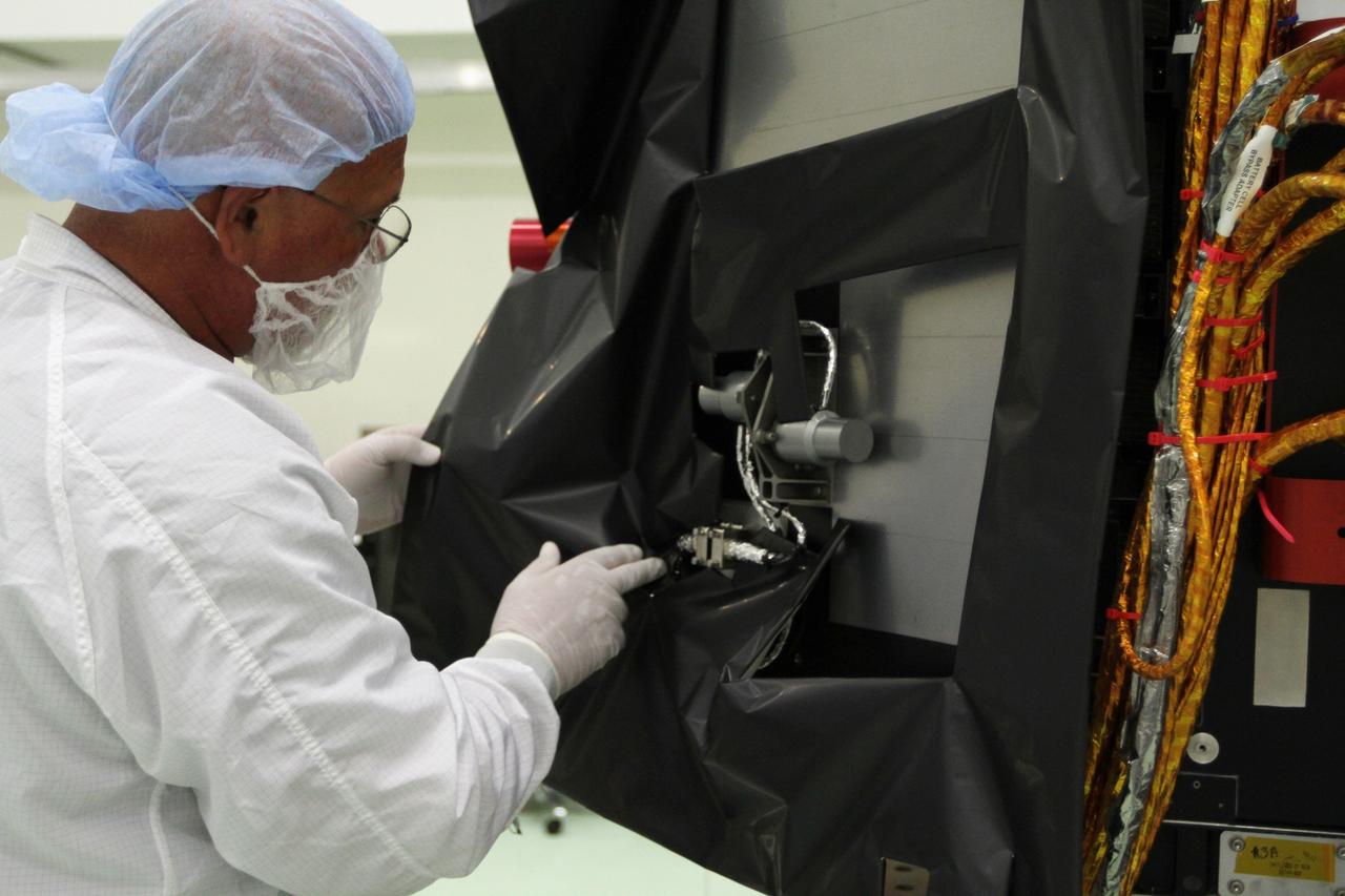CAPE CANAVERAL, Fla. – Inside the Astrotech payload processing facility near NASA’s Kennedy Space Center in Florida, a technician installs protective thermal blankets around the Radiation Belt Storm Probes, or RBSP, spacecraft A. NASA’s RBSP mission will help us understand the sun’s influence on Earth and near-Earth space by studying the Earth’s radiation belts on various scales of space and time. RBSP will begin its mission of exploration of Earth’s Van Allen radiation belts and the extremes of space weather after its launch aboard a United Launch Alliance Atlas V rocket. Launch is targeted for Aug. 23. For more information, visit http://www.nasa.gov/rbsp. Photo credit: NASA/Kim Shiflett