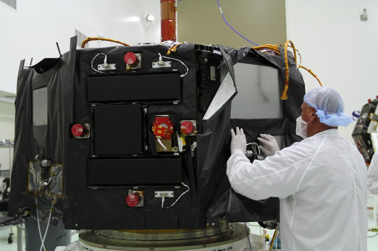 CAPE CANAVERAL, Fla. – Inside the Astrotech payload processing facility near NASA’s Kennedy Space Center in Florida, a technician installs protective thermal blankets around the Radiation Belt Storm Probes, or RBSP, spacecraft A. NASA’s RBSP mission will help us understand the sun’s influence on Earth and near-Earth space by studying the Earth’s radiation belts on various scales of space and time. RBSP will begin its mission of exploration of Earth’s Van Allen radiation belts and the extremes of space weather after its launch aboard a United Launch Alliance Atlas V rocket. Launch is targeted for Aug. 23. For more information, visit http://www.nasa.gov/rbsp. Photo credit: NASA/Kim Shiflett