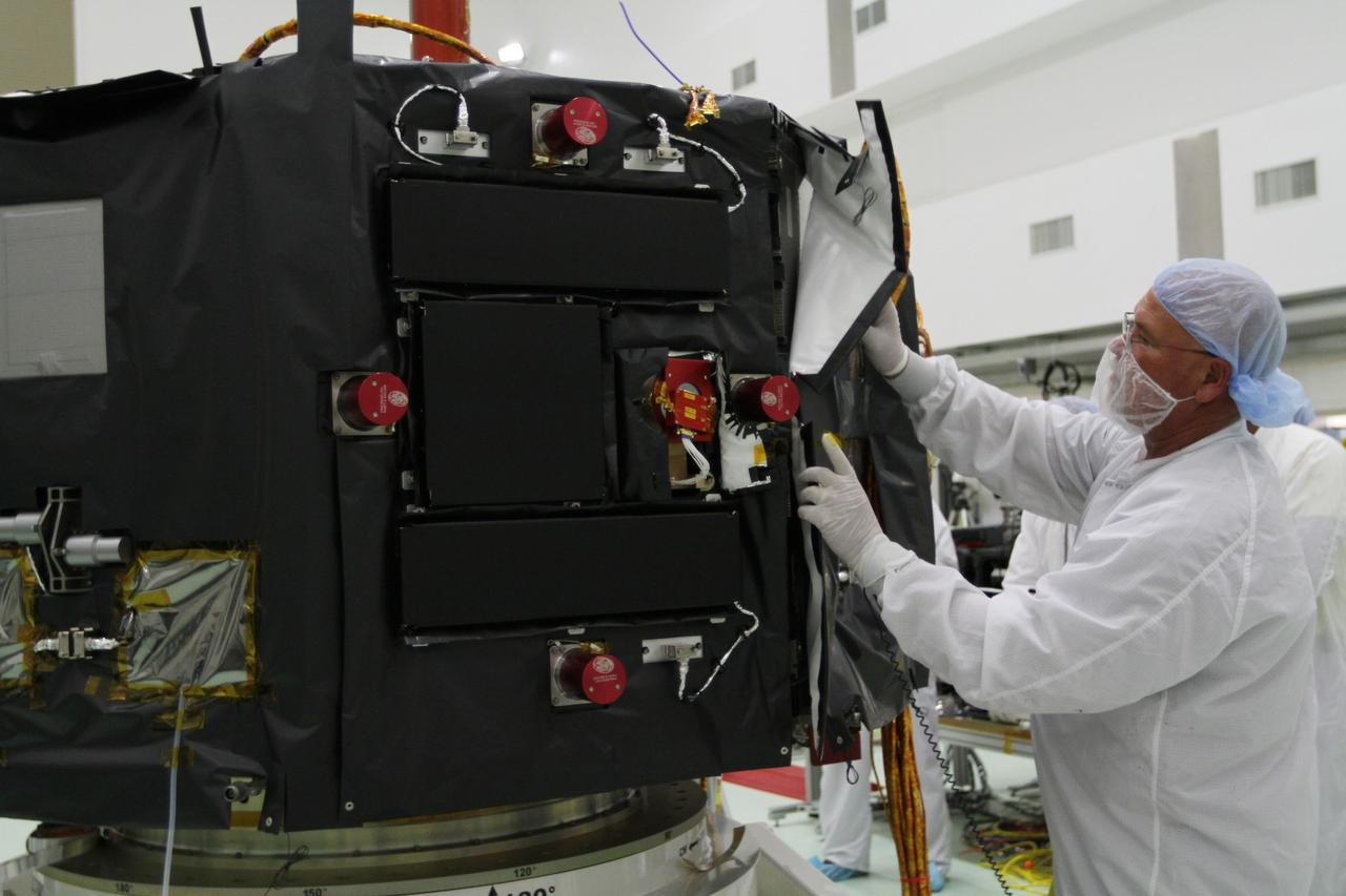 CAPE CANAVERAL, Fla. – Inside the Astrotech payload processing facility near NASA’s Kennedy Space Center in Florida, a technician installs protective thermal blankets around the Radiation Belt Storm Probes, or RBSP, spacecraft A. NASA’s RBSP mission will help us understand the sun’s influence on Earth and near-Earth space by studying the Earth’s radiation belts on various scales of space and time. RBSP will begin its mission of exploration of Earth’s Van Allen radiation belts and the extremes of space weather after its launch aboard a United Launch Alliance Atlas V rocket. Launch is targeted for Aug. 23. For more information, visit http://www.nasa.gov/rbsp. Photo credit: NASA/Kim Shiflett