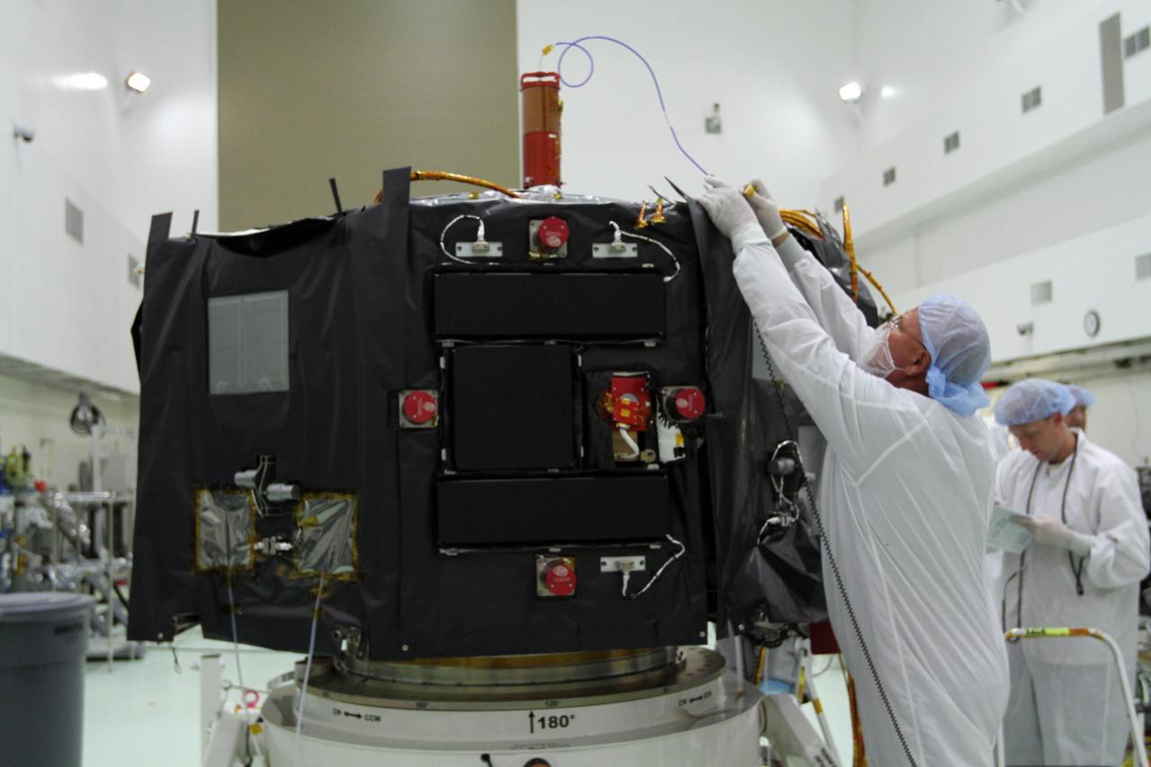 CAPE CANAVERAL, Fla. – Inside the Astrotech payload processing facility near NASA’s Kennedy Space Center in Florida, technicians install protective thermal blankets around the Radiation Belt Storm Probes, or RBSP, spacecraft A. NASA’s RBSP mission will help us understand the sun’s influence on Earth and near-Earth space by studying the Earth’s radiation belts on various scales of space and time. RBSP will begin its mission of exploration of Earth’s Van Allen radiation belts and the extremes of space weather after its launch aboard a United Launch Alliance Atlas V rocket. Launch is targeted for Aug. 23. For more information, visit http://www.nasa.gov/rbsp. Photo credit: NASA/Kim Shiflett