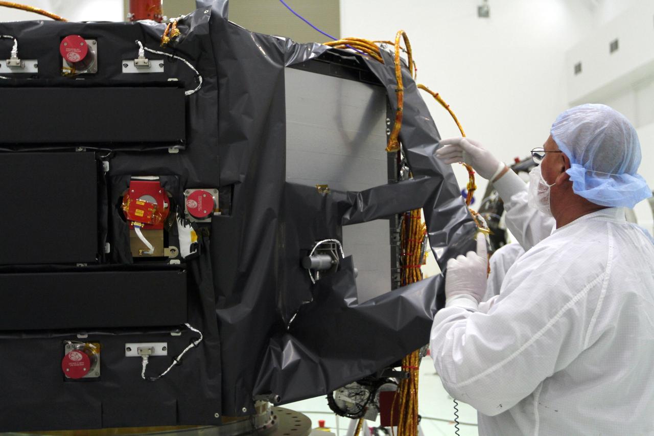 CAPE CANAVERAL, Fla. – Inside the Astrotech payload processing facility near NASA’s Kennedy Space Center in Florida, a technician installs protective thermal blankets around the Radiation Belt Storm Probes, or RBSP, spacecraft A. NASA’s RBSP mission will help us understand the sun’s influence on Earth and near-Earth space by studying the Earth’s radiation belts on various scales of space and time. RBSP will begin its mission of exploration of Earth’s Van Allen radiation belts and the extremes of space weather after its launch aboard a United Launch Alliance Atlas V rocket. Launch is targeted for Aug. 23. For more information, visit http://www.nasa.gov/rbsp. Photo credit: NASA/Kim Shiflett