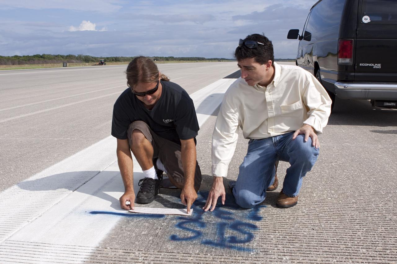CAPE CANAVERAL, Fla. - At the Shuttle Landing Facility SLF at NASA’s Kennedy Space Center in Florida, United Space Alliance technicians make preparations to mark the final front and rear wheel stop locations of an orbiter. Space shuttle Atlantis completed the STS-135 mission by landing at the SLF on July 21, 2011, at 5:57 a.m.     A special plaque will be permanently mounted at the runway’s edge to commemorate the final shuttle landing. Atlantis flew 33 missions, completed 4,848 orbits of the Earth, traveled nearly 126 million miles and spent 307 days in space. Atlantis carried 207 astronauts to space.  Photo credit: NASA/Jim Grossmann