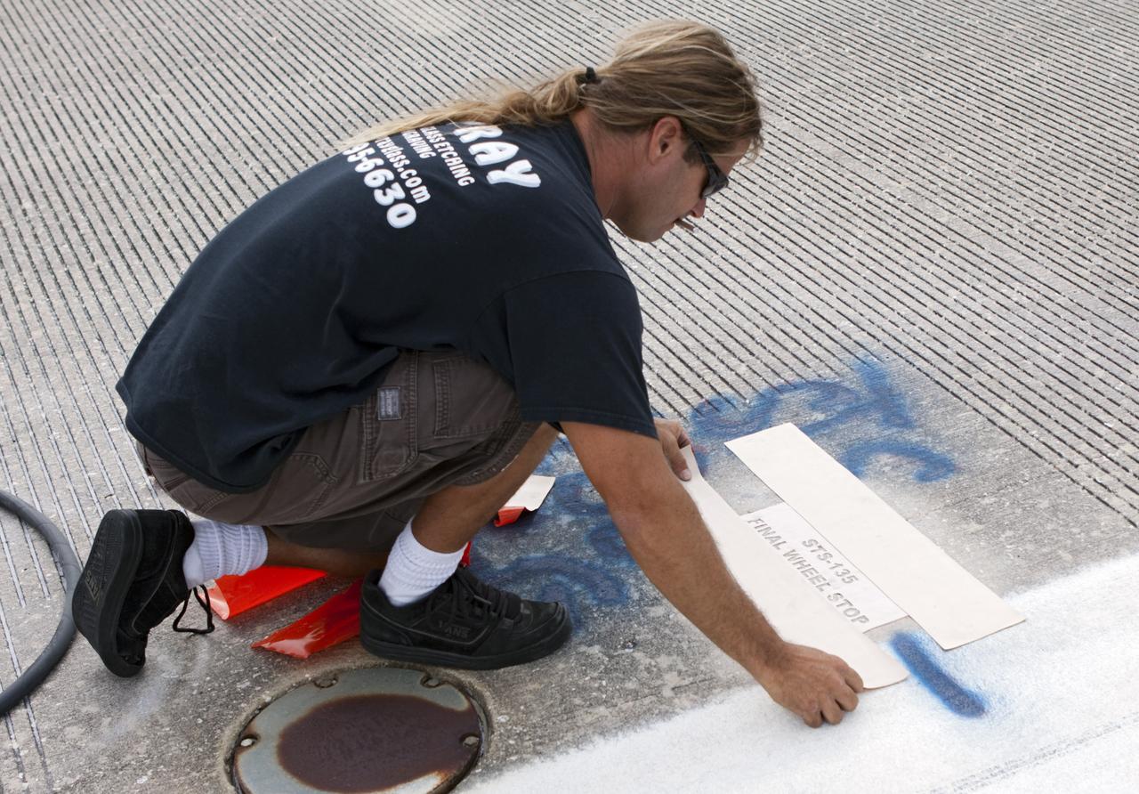 CAPE CANAVERAL, Fla. - At the Shuttle Landing Facility SLF at NASA’s Kennedy Space Center in Florida, a United Space Alliance technician marks the final front and rear wheel stop locations of an orbiter. Space shuttle Atlantis completed the STS-135 mission by landing at the SLF on July 21, 2011, at 5:57 a.m.     A special plaque will be permanently mounted at the runway’s edge to commemorate the final shuttle landing. Atlantis flew 33 missions, completed 4,848 orbits of the Earth, traveled nearly 126 million miles and spent 307 days in space. Atlantis carried 207 astronauts to space.  Photo credit: NASA/Jim Grossmann