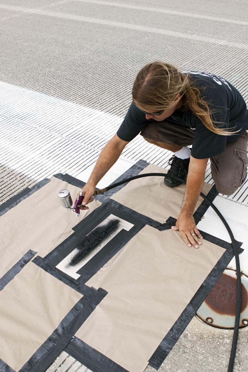 CAPE CANAVERAL, Fla. - At the Shuttle Landing Facility SLF at NASA’s Kennedy Space Center in Florida, a United Space Alliance technician marks the final front and rear wheel stop locations of an orbiter. Space shuttle Atlantis completed the STS-135 mission by landing at the SLF on July 21, 2011, at 5:57 a.m.     A special plaque will be permanently mounted at the runway’s edge to commemorate the final shuttle landing. Atlantis flew 33 missions, completed 4,848 orbits of the Earth, traveled nearly 126 million miles and spent 307 days in space. Atlantis carried 207 astronauts to space.  Photo credit: NASA/Jim Grossmann