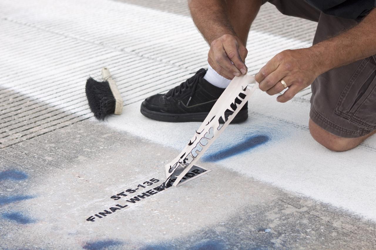 CAPE CANAVERAL, Fla. - At the Shuttle Landing Facility SLF at NASA’s Kennedy Space Center in Florida, a United Space Alliance technician marks the final front and rear wheel stop locations of an orbiter. Space shuttle Atlantis completed the STS-135 mission by landing at the SLF on July 21, 2011, at 5:57 a.m.     A special plaque will be permanently mounted at the runway’s edge to commemorate the final shuttle landing. Atlantis flew 33 missions, completed 4,848 orbits of the Earth, traveled nearly 126 million miles and spent 307 days in space. Atlantis carried 207 astronauts to space.  Photo credit: NASA/Jim Grossmann