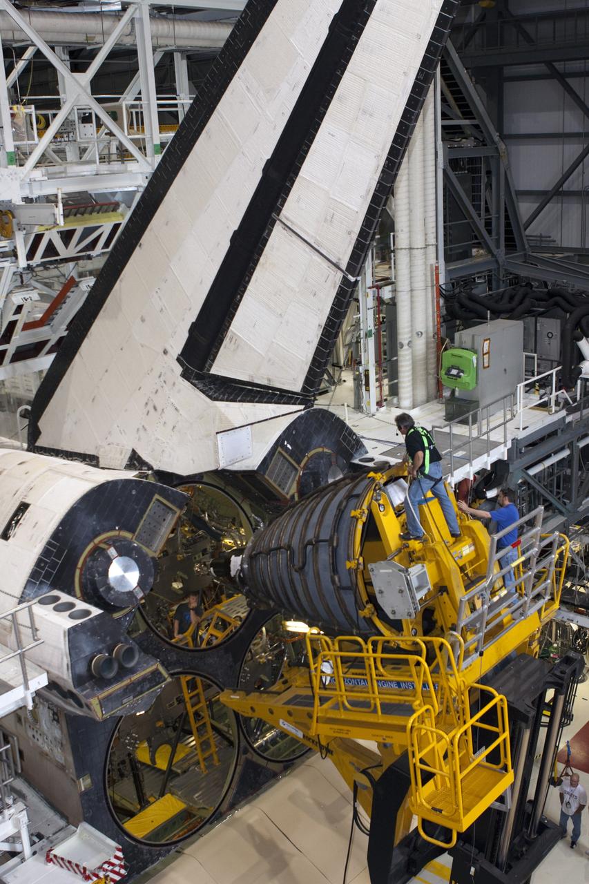 CAPE CANAVERAL, Fla. – In Orbiter Processing Facility-1 at NASA’s Kennedy Space Center in Florida, technicians sitting on the Hyster forklift monitor the progress as they guide replica shuttle main engine RSME number 1 toward space shuttle Atlantis. Three RSMEs will be installed on Atlantis. The work is part of the Space Shuttle Program’s transition and retirement processing of the space shuttle fleet. A groundbreaking was held Jan. 18 for Atlantis’ future home, a 65,000-square-foot exhibit hall in Shuttle Plaza at the Kennedy Space Center Visitor Complex. Atlantis is scheduled to roll over to the visitor complex in November in preparation for the exhibit’s grand opening in July 2013. For more information, visit http://www.nasa.gov/transition. Photo credit: NASA/Jim Grossmann