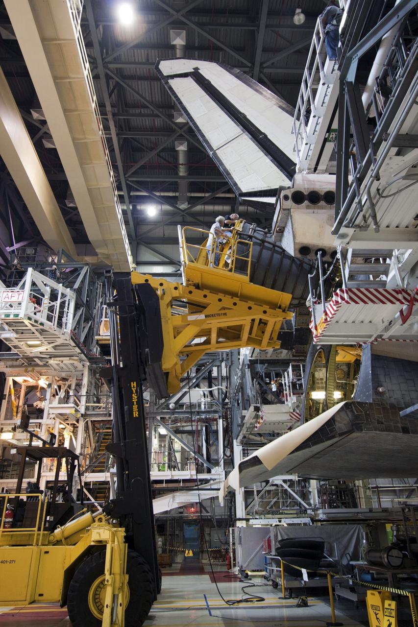 CAPE CANAVERAL, Fla. – In Orbiter Processing Facility-1 at NASA’s Kennedy Space Center in Florida, technicians sitting on the Hyster forklift monitor the progress as they guide replica shuttle main engine RSME number 1 toward space shuttle Atlantis. Three RSMEs will be installed on Atlantis. The work is part of the Space Shuttle Program’s transition and retirement processing of the space shuttle fleet. A groundbreaking was held Jan. 18 for Atlantis’ future home, a 65,000-square-foot exhibit hall in Shuttle Plaza at the Kennedy Space Center Visitor Complex. Atlantis is scheduled to roll over to the visitor complex in November in preparation for the exhibit’s grand opening in July 2013. For more information, visit http://www.nasa.gov/transition. Photo credit: NASA/Jim Grossmann