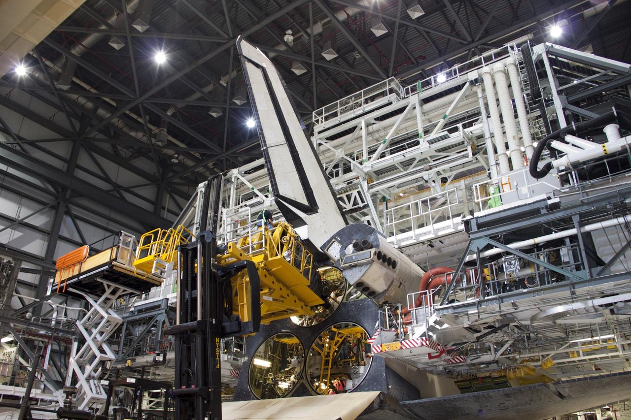 CAPE CANAVERAL, Fla. – In Orbiter Processing Facility-1 at NASA’s Kennedy Space Center in Florida, technicians sitting on the Hyster forklift monitor the progress as they guide replica shuttle main engine RSME number 1 toward space shuttle Atlantis. Three RSMEs will be installed on Atlantis. The work is part of the Space Shuttle Program’s transition and retirement processing of the space shuttle fleet. A groundbreaking was held Jan. 18 for Atlantis’ future home, a 65,000-square-foot exhibit hall in Shuttle Plaza at the Kennedy Space Center Visitor Complex. Atlantis is scheduled to roll over to the visitor complex in November in preparation for the exhibit’s grand opening in July 2013. For more information, visit http://www.nasa.gov/transition. Photo credit: NASA/Jim Grossmann