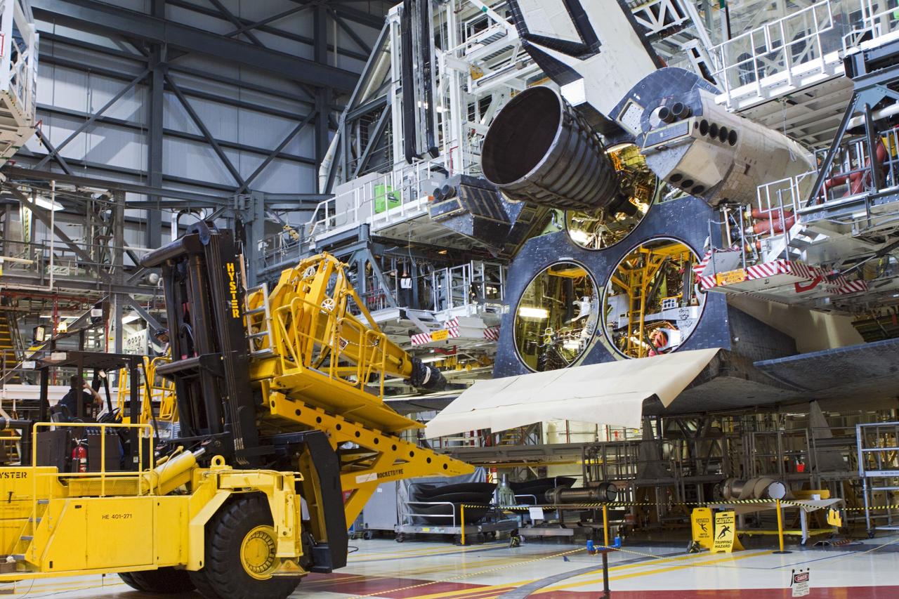 CAPE CANAVERAL, Fla. – In Orbiter Processing Facility-1 at NASA’s Kennedy Space Center in Florida, technicians used a Hyster forklift to install replica shuttle main engine RSME number 1 on space shuttle Atlantis. Three RSMEs will be installed on Atlantis. The work is part of the Space Shuttle Program’s transition and retirement processing of the space shuttle fleet. A groundbreaking was held Jan. 18 for Atlantis’ future home, a 65,000-square-foot exhibit hall in Shuttle Plaza at the Kennedy Space Center Visitor Complex. Atlantis is scheduled to roll over to the visitor complex in November in preparation for the exhibit’s grand opening in July 2013. For more information, visit http://www.nasa.gov/transition. Photo credit: NASA/Jim Grossmann