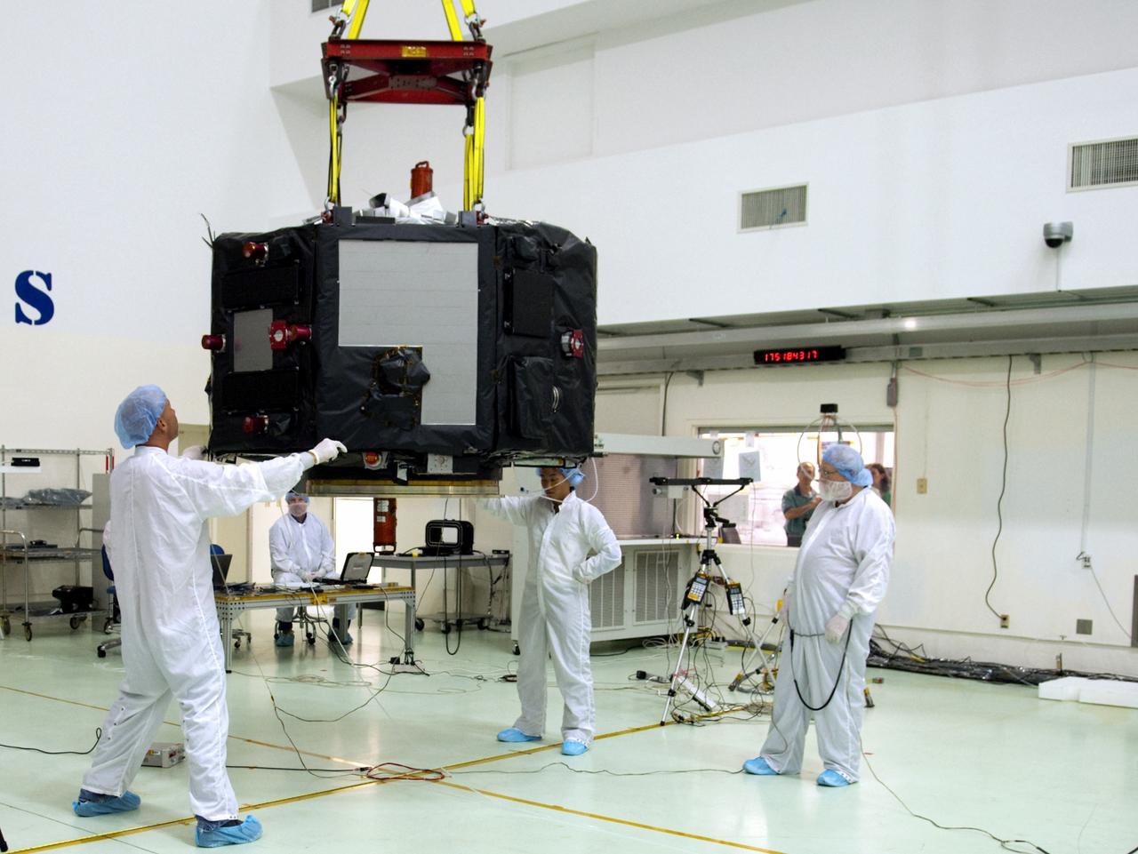 CAPE CANAVERAL, Fla. – Inside the Astrotech payload processing facility near NASA’s Kennedy Space Center in Florida, technicians line up the Radiation Belt Storm Probes, or RBSP, spacecraft A over an electromagnetic source in order to perform a magnetic swing test. The magnetic swing test is performed to characterize the magnetic signature of the spacecraft so that when it is taking measurements with its sensors in space scientists can subtract out background noise from the spacecraft itself. NASA’s RBSP mission will help us understand the sun’s influence on Earth and near-Earth space by studying the Earth’s radiation belts on various scales of space and time. RBSP will begin its mission of exploration of Earth’s Van Allen radiation belts and the extremes of space weather after its launch aboard a United Launch Alliance Atlas V rocket. Launch is targeted for Aug. 23. For more information, visit http://www.nasa.gov/rbsp. Photo credit: NASA/Charisse Nahser