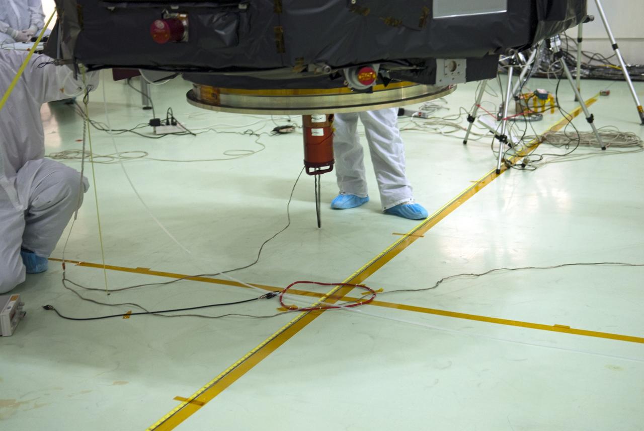 CAPE CANAVERAL, Fla. – Inside the Astrotech payload processing facility near NASA’s Kennedy Space Center in Florida, technicians line up the Radiation Belt Storm Probes, or RBSP, spacecraft A over an electromagnetic source in order to perform a magnetic swing test. The magnetic swing test is performed to characterize the magnetic signature of the spacecraft so that when it is taking measurements with its sensors in space scientists can subtract out background noise from the spacecraft itself. NASA’s RBSP mission will help us understand the sun’s influence on Earth and near-Earth space by studying the Earth’s radiation belts on various scales of space and time. RBSP will begin its mission of exploration of Earth’s Van Allen radiation belts and the extremes of space weather after its launch aboard a United Launch Alliance Atlas V rocket. Launch is targeted for Aug. 23. For more information, visit http://www.nasa.gov/rbsp. Photo credit: NASA/Charisse Nahser