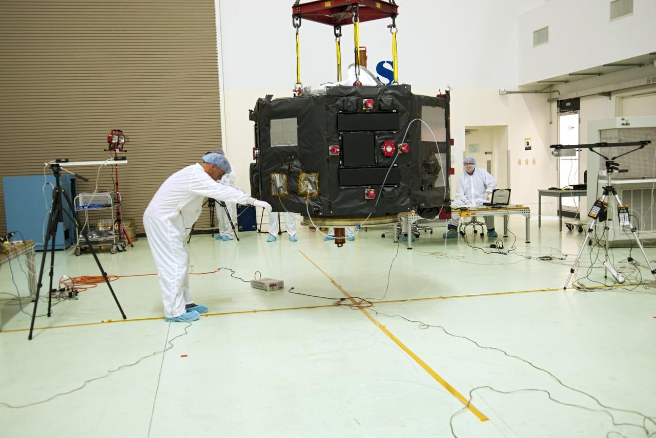 CAPE CANAVERAL, Fla. – Inside the Astrotech payload processing facility near NASA’s Kennedy Space Center in Florida, technicians line up the Radiation Belt Storm Probes, or RBSP, spacecraft A over an electromagnetic source in order to perform a magnetic swing test. The magnetic swing test is performed to characterize the magnetic signature of the spacecraft so that when it is taking measurements with its sensors in space scientists can subtract out background noise from the spacecraft itself. NASA’s RBSP mission will help us understand the sun’s influence on Earth and near-Earth space by studying the Earth’s radiation belts on various scales of space and time. RBSP will begin its mission of exploration of Earth’s Van Allen radiation belts and the extremes of space weather after its launch aboard a United Launch Alliance Atlas V rocket. Launch is targeted for Aug. 23. For more information, visit http://www.nasa.gov/rbsp. Photo credit: NASA/Charisse Nahser