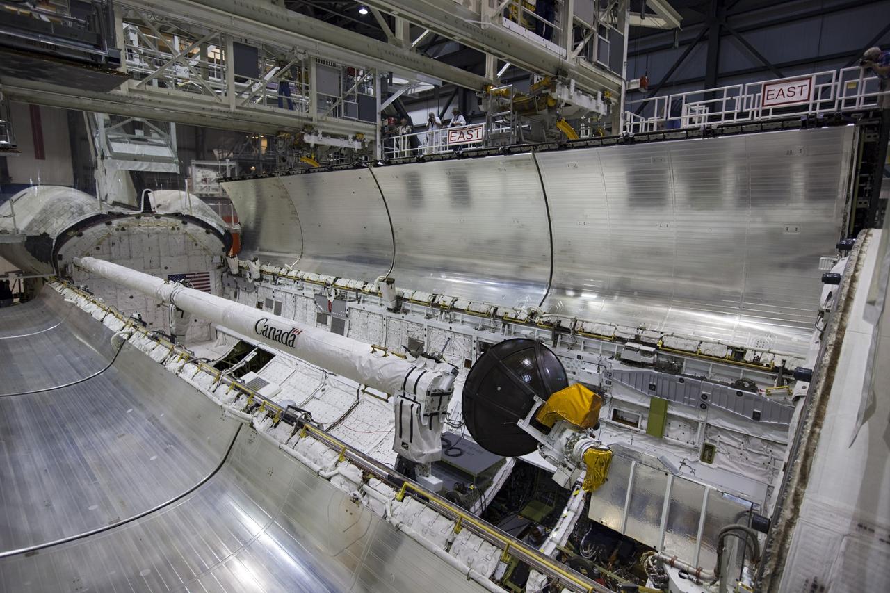 CAPE CANAVERAL, Fla. – Inside Orbiter Processing Facility-1 at NASA’s Kennedy Space Center in Florida, one of the two payload bay doors on space shuttle Atlantis begins to close in preparation for its move to the Vehicle Assembly Building. The work is part of the Space Shuttle Program’s transition and retirement processing of the space shuttle fleet. A groundbreaking was held Jan. 18 for Atlantis’ future home, a 65,000-square-foot exhibit hall in Shuttle Plaza at the Kennedy Space Center Visitor Complex. Atlantis is scheduled to roll over to the visitor complex in November in preparation for the exhibit’s grand opening in July 2013. For more information, visit http://www.nasa.gov/shuttle. Photo credit: NASA/Dimitri Gerondidakis
