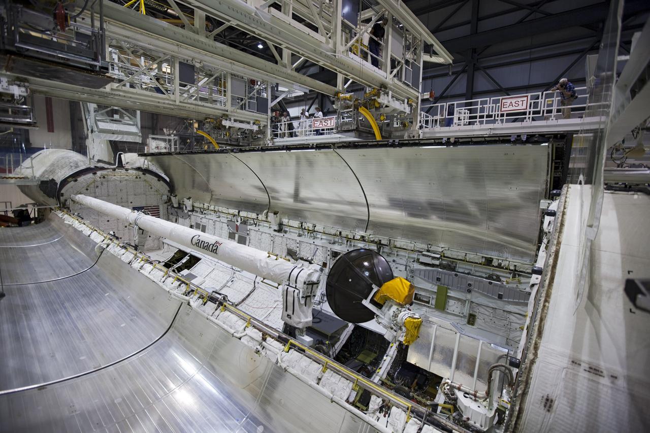 CAPE CANAVERAL, Fla. – Inside Orbiter Processing Facility-1 at NASA’s Kennedy Space Center in Florida, one of the two payload bay doors on space shuttle Atlantis begins to close in preparation for its move to the Vehicle Assembly Building. The work is part of the Space Shuttle Program’s transition and retirement processing of the space shuttle fleet. A groundbreaking was held Jan. 18 for Atlantis’ future home, a 65,000-square-foot exhibit hall in Shuttle Plaza at the Kennedy Space Center Visitor Complex. Atlantis is scheduled to roll over to the visitor complex in November in preparation for the exhibit’s grand opening in July 2013. For more information, visit http://www.nasa.gov/shuttle. Photo credit: NASA/Dimitri Gerondidakis