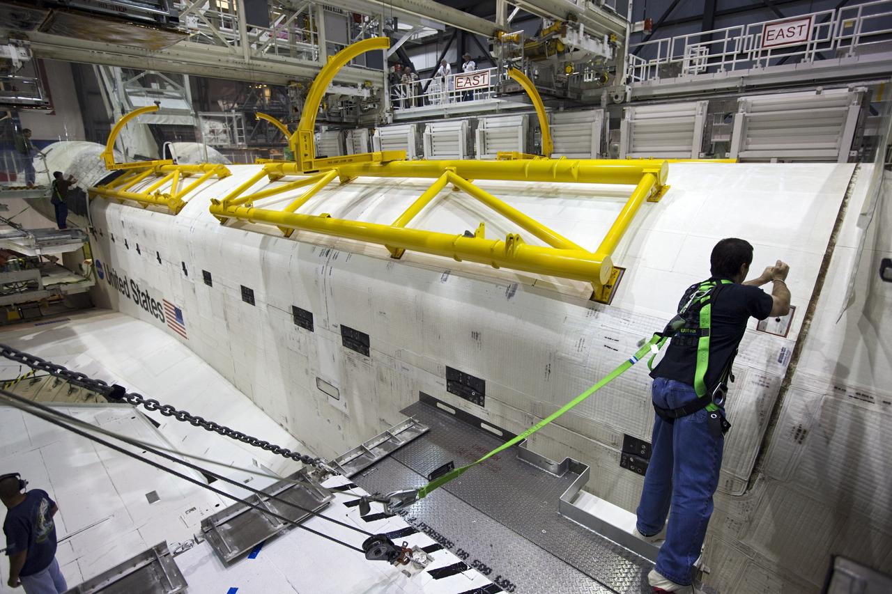 CAPE CANAVERAL, Fla. – Inside Orbiter Processing Facility-1 at NASA’s Kennedy Space Center in Florida, United Space Alliance technicians inspect space shuttle Atlantis’ payload bay doors after they were closed in preparation for its move to the Vehicle Assembly Building. The work is part of the Space Shuttle Program’s transition and retirement processing of the space shuttle fleet. A groundbreaking was held Jan. 18 for Atlantis’ future home, a 65,000-square-foot exhibit hall in Shuttle Plaza at the Kennedy Space Center Visitor Complex. Atlantis is scheduled to roll over to the visitor complex in November in preparation for the exhibit’s grand opening in July 2013. For more information, visit http://www.nasa.gov/shuttle. Photo credit: NASA/Dimitri Gerondidakis
