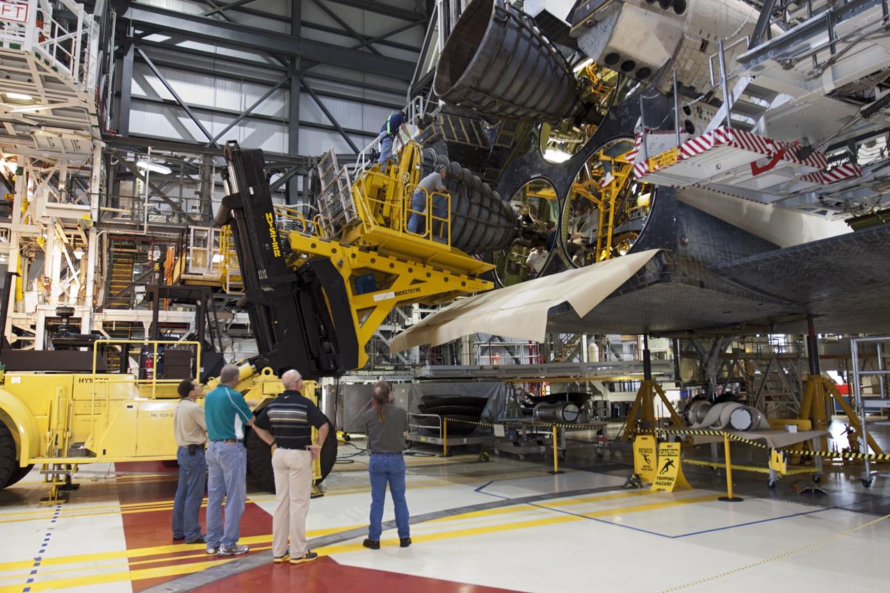 CAPE CANAVERAL, Fla. – In Orbiter Processing Facility-1 at NASA’s Kennedy Space Center in Florida, technicians on the Hyster forklift position replica shuttle main engine RSME number 2 for installation on space shuttle Atlantis. Three RSMEs will be installed on Atlantis. The work is part of the Space Shuttle Program’s transition and retirement processing of the space shuttle fleet. A groundbreaking was held Jan. 18 for Atlantis’ future home, a 65,000-square-foot exhibit hall in Shuttle Plaza at the Kennedy Space Center Visitor Complex. Atlantis is scheduled to roll over to the visitor complex in November in preparation for the exhibit’s grand opening in July 2013. For more information, visit http://www.nasa.gov/transition. Photo credit: NASA/Glenn Benson