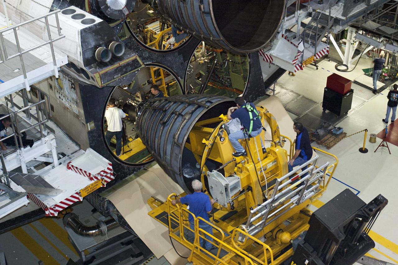 CAPE CANAVERAL, Fla. – In Orbiter Processing Facility-1 at NASA’s Kennedy Space Center in Florida, technicians sitting on the Hyster forklift monitor the progress as technicians in the aft portion of space shuttle Atlantis connect replica shuttle main engine RSME number 2. Three RSMEs will be installed on Atlantis. The work is part of the Space Shuttle Program’s transition and retirement processing of the space shuttle fleet. A groundbreaking was held Jan. 18 for Atlantis’ future home, a 65,000-square-foot exhibit hall in Shuttle Plaza at the Kennedy Space Center Visitor Complex. Atlantis is scheduled to roll over to the visitor complex in November in preparation for the exhibit’s grand opening in July 2013. For more information, visit http://www.nasa.gov/transition. Photo credit: NASA/Glenn Benson