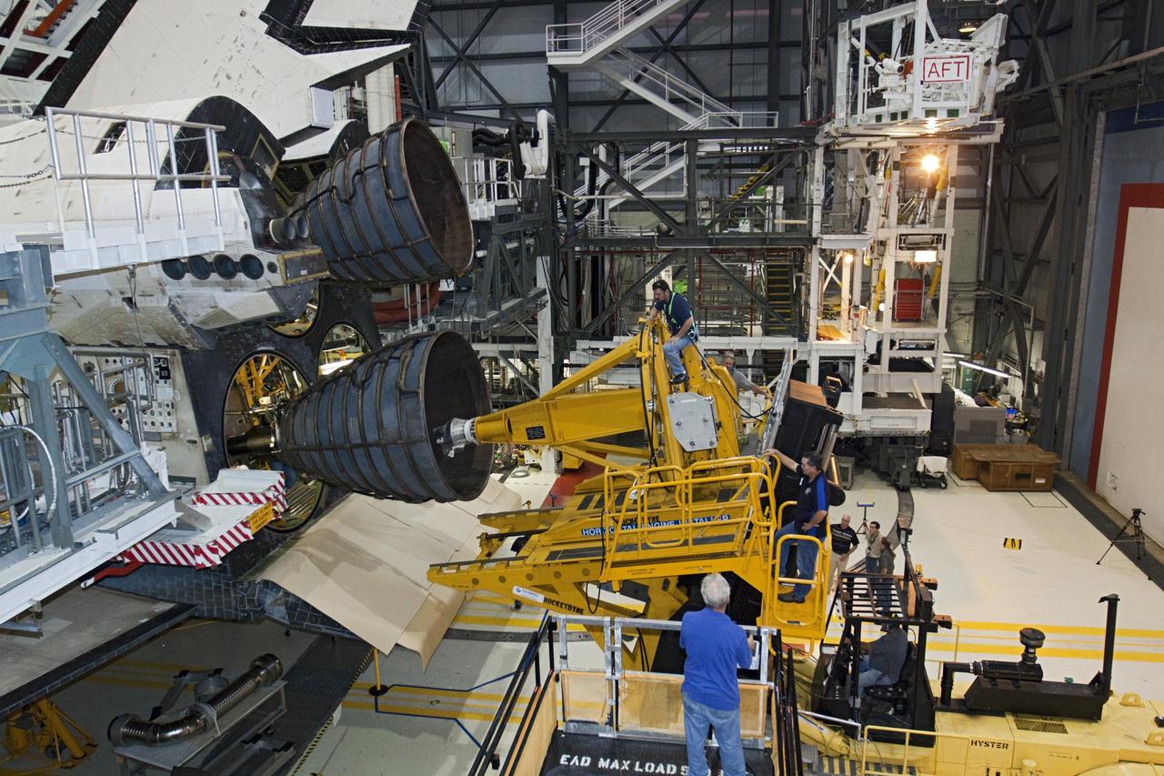 CAPE CANAVERAL, Fla. – In Orbiter Processing Facility-1 at NASA’s Kennedy Space Center in Florida, technicians sitting on the Hyster forklift monitor the progress as technicians in the aft portion of space shuttle Atlantis connect replica shuttle main engine RSME number 2. Three RSMEs will be installed on Atlantis. The work is part of the Space Shuttle Program’s transition and retirement processing of the space shuttle fleet. A groundbreaking was held Jan. 18 for Atlantis’ future home, a 65,000-square-foot exhibit hall in Shuttle Plaza at the Kennedy Space Center Visitor Complex. Atlantis is scheduled to roll over to the visitor complex in November in preparation for the exhibit’s grand opening in July 2013. For more information, visit http://www.nasa.gov/transition. Photo credit: NASA/Glenn Benson