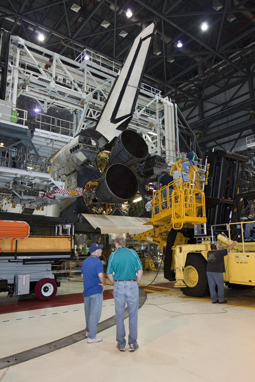 CAPE CANAVERAL, Fla. – In Orbiter Processing Facility-1 at NASA’s Kennedy Space Center in Florida, technicians on the Hyster forklift and in the facility monitor the progress as replica shuttle main engine RSME number 2 is installed on space shuttle Atlantis. Three RSMEs will be installed on Atlantis. The work is part of the Space Shuttle Program’s transition and retirement processing of the space shuttle fleet. A groundbreaking was held Jan. 18 for Atlantis’ future home, a 65,000-square-foot exhibit hall in Shuttle Plaza at the Kennedy Space Center Visitor Complex. Atlantis is scheduled to roll over to the visitor complex in November in preparation for the exhibit’s grand opening in July 2013. For more information, visit http://www.nasa.gov/transition. Photo credit: NASA/Glenn Benson