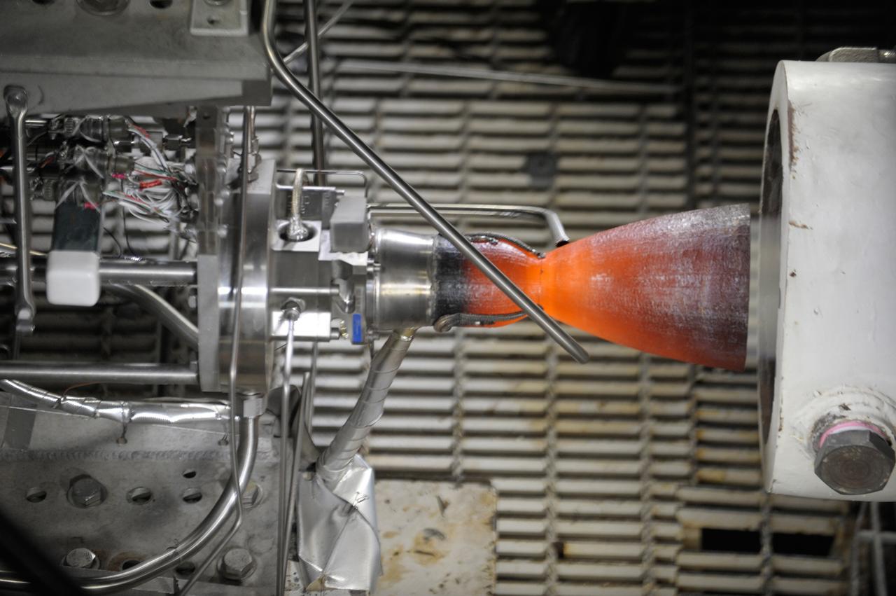 LAS CRUCES, N.M. -- Pratt & Whitney Rocketdyne tests a thruster destined for Boeing's CST-100 spacecraft. The thruster was fired in a vacuum chamber that simulated a space-like environment of 100,000 feet at NASA's White Sands Test Facility in Las Cruces, N.M., to verify its durability in extreme heat, evaluate the opening and closing of its valves and confirm continuous combustion and performance. Twenty-four thrusters will be part of the spacecraft's orbital maneuvering and attitude control system OMAC, giving the CST-100 the ability to maneuver in space and during re-entry. The thrusters also will allow the spacecraft to separate from its launch vehicle if an abort becomes necessary during launch or ascent.      In 2011, NASA selected Boeing of Houston during Commercial Crew Development Round 2 CCDev2) activities to mature the design and development of a crew transportation system with the overall goal of accelerating a United States-led capability to the International Space Station. The goal of CCP is to drive down the cost of space travel as well as open up space to more people than ever before by balancing industry’s own innovative capabilities with NASA's 50 years of human spaceflight experience. Six other aerospace companies also are maturing launch vehicle and spacecraft designs under CCDev2, including Alliant Techsystems Inc. ATK, Blue Origin, Excalibur Almaz Inc., Sierra Nevada Corp., Space Exploration Technologies SpaceX, and United Launch Alliance ULA. For more information, visit www.nasa.gov/commercialcrew. Image credit: Pratt & Whitney Rocketdyne