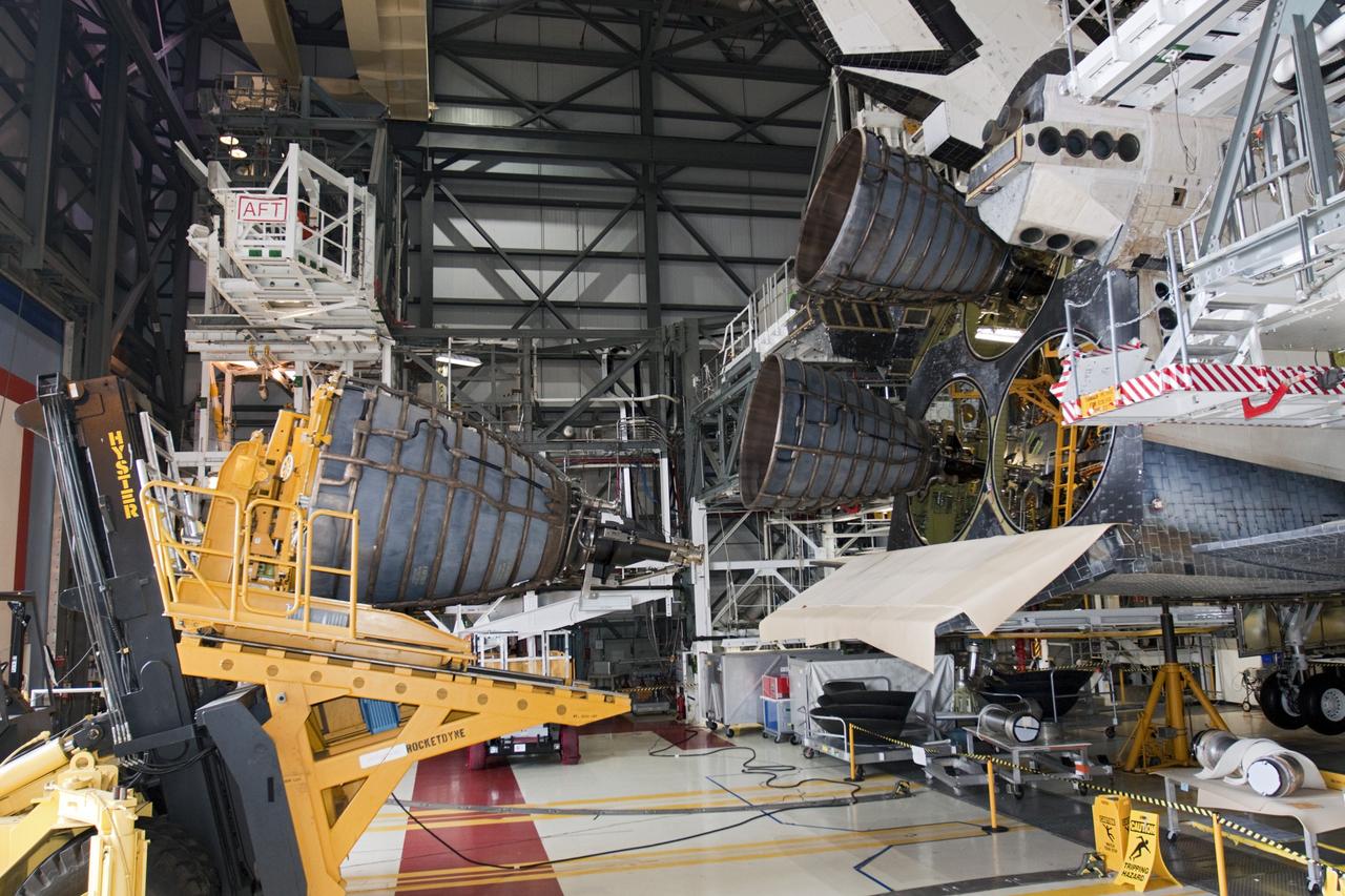 CAPE CANAVERAL, Fla. - In Orbiter Processing Facility Bay 1 at NASA’s Kennedy Space Center in Florida, technicians move the Hyster forklift into position for installation of replica shuttle main engine RSME number 2 on the space shuttle Atlantis. Three RSMEs were installed on Atlantis. The replicas were built in the Pratt & Whitney Rocketdyne engine shop at KSC to replace the space shuttle main engines SSMEs which will be placed in storage to support NASA's Space Launch System currently under development. The RSME installation is part of the Space Shuttle Program’s transition and retirement processing of the space shuttle fleet. A groundbreaking was held Jan. 18, 2012 for Atlantis’ future home, a 65,000-square-foot exhibit hall in Shuttle Plaza at the Kennedy Space Center Visitor Complex. Atlantis is scheduled to roll over to the visitor complex during November in preparation for the exhibit’s grand opening in July 2013. For more information, visit http://www.nasa.gov/transition. Photo credit: NASA/Glenn Benson