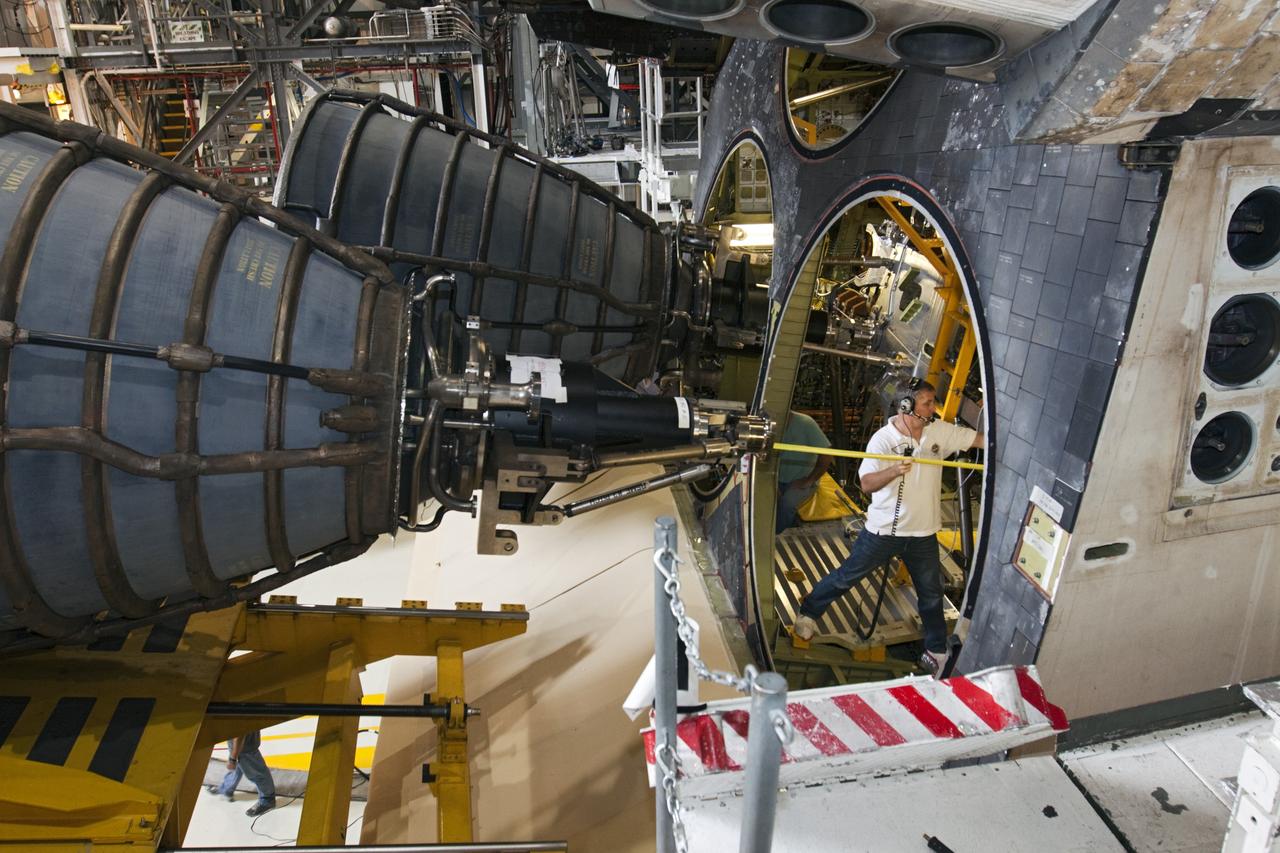 CAPE CANAVERAL, Fla. - A technician stands inside the aft compartment of the space shuttle Atlantis during preparations to install replica shuttle main engine RSME number 2 in Orbiter Processing Facility Bay 1 at NASA’s Kennedy Space Center in Florida. Three RSMEs were installed on Atlantis. The replicas were built in the Pratt & Whitney Rocketdyne engine shop at KSC to replace the space shuttle main engines SSMEs which will be placed in storage to support NASA's Space Launch System currently under development. The RSME installation is part of the Space Shuttle Program’s transition and retirement processing of the space shuttle fleet. A groundbreaking was held Jan. 18, 2012 for Atlantis’ future home, a 65,000-square-foot exhibit hall in Shuttle Plaza at the Kennedy Space Center Visitor Complex. Atlantis is scheduled to roll over to the visitor complex during November in preparation for the exhibit’s grand opening in July 2013. For more information, visit http://www.nasa.gov/transition. Photo credit: NASA/Glenn Benson