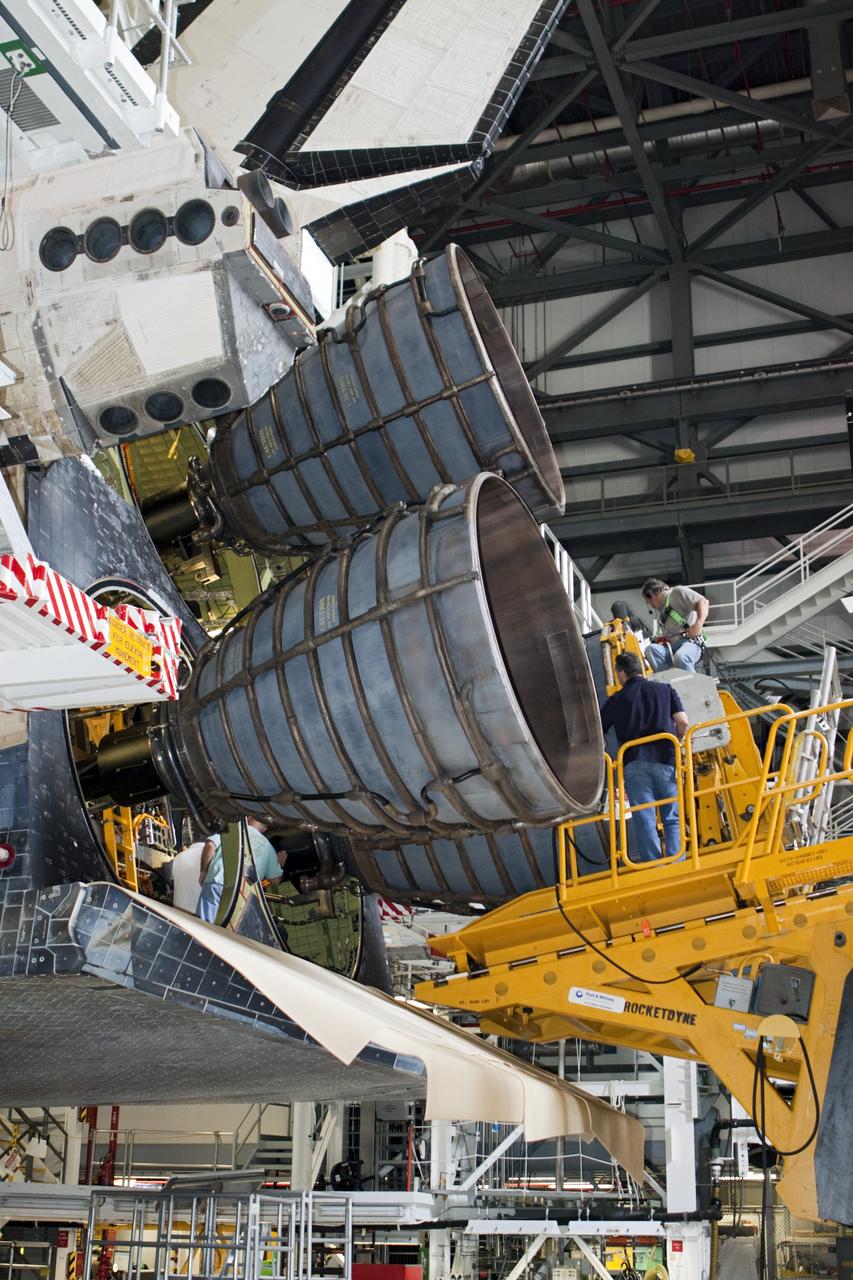 CAPE CANAVERAL, Fla. - In Orbiter Processing Facility Bay 1 at NASA’s Kennedy Space Center in Florida, technicians stand on the Hyster forklift as replica shuttle main engine RSME number 2 is installed on the space shuttle Atlantis. Three RSMEs were installed on Atlantis. The replicas were built in the Pratt & Whitney Rocketdyne engine shop at KSC to replace the space shuttle main engines SSMEs which will be placed in storage to support NASA's Space Launch System currently under development. The RSME installation is part of the Space Shuttle Program’s transition and retirement processing of the space shuttle fleet. A groundbreaking was held Jan. 18, 2012 for Atlantis’ future home, a 65,000-square-foot exhibit hall in Shuttle Plaza at the Kennedy Space Center Visitor Complex. Atlantis is scheduled to roll over to the visitor complex during November in preparation for the exhibit’s grand opening in July 2013. For more information, visit http://www.nasa.gov/transition. Photo credit: NASA/Glenn Benson