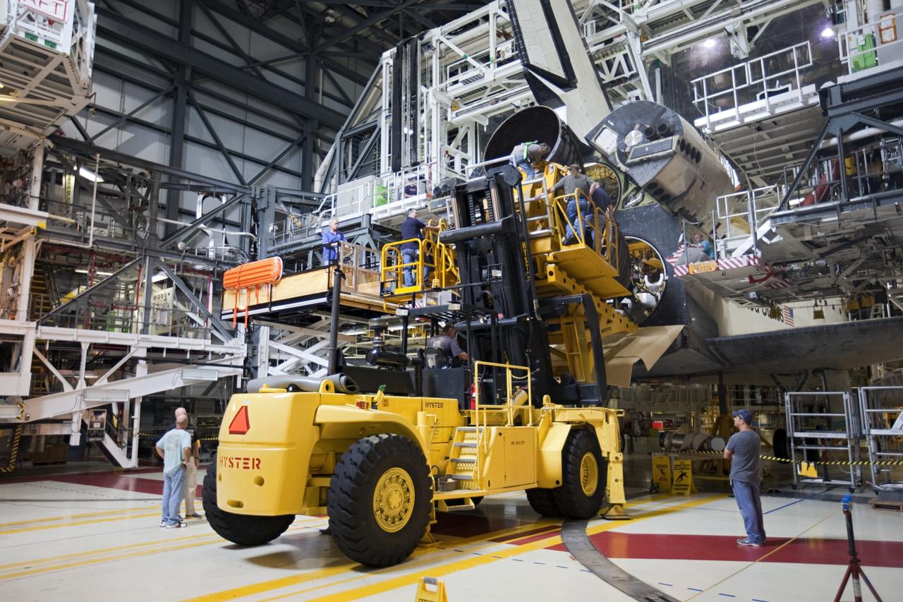 CAPE CANAVERAL, Fla. - In Orbiter Processing Facility Bay 1 at NASA’s Kennedy Space Center in Florida, technicians use the Hyster forklift to install replica shuttle main engine RSME number 2 on the space shuttle Atlantis. Three RSMEs were installed on Atlantis. The replicas were built in the Pratt & Whitney Rocketdyne engine shop at KSC to replace the space shuttle main engines SSMEs which will be placed in storage to support NASA's Space Launch System currently under development. The RSME installation is part of the Space Shuttle Program’s transition and retirement processing of the space shuttle fleet. A groundbreaking was held Jan. 18, 2012 for Atlantis’ future home, a 65,000-square-foot exhibit hall in Shuttle Plaza at the Kennedy Space Center Visitor Complex. Atlantis is scheduled to roll over to the visitor complex during November in preparation for the exhibit’s grand opening in July 2013. For more information, visit http://www.nasa.gov/transition. Photo credit: NASA/Glenn Benson