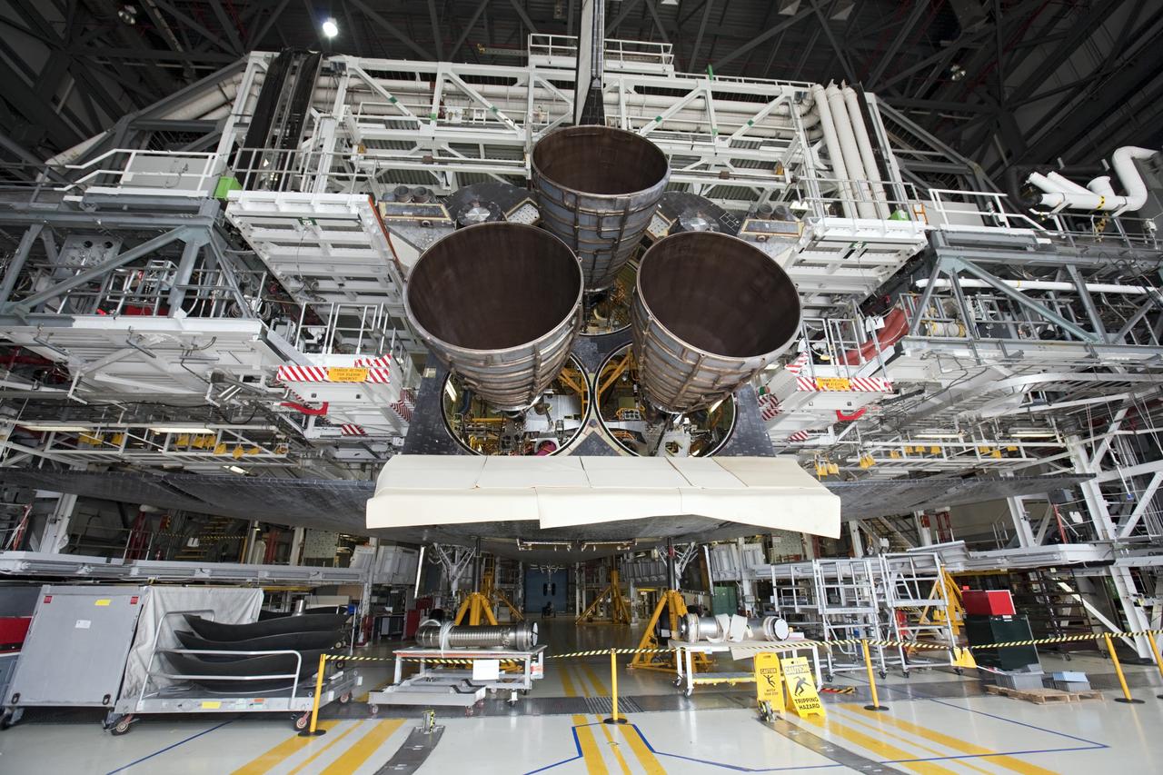 CAPE CANAVERAL, Fla. - In Orbiter Processing Facility Bay 1 at NASA’s Kennedy Space Center in Florida, three replica shuttle main engines RSMEs have been installed on the space shuttle Atlantis. In this wide-angle view, the orbiter is surrounded by work platforms allowing access to all areas of the spacecraft. Three RSMEs were installed on Atlantis. The replicas were built in the Pratt & Whitney Rocketdyne engine shop at KSC to replace the space shuttle main engines SSMEs which will be placed in storage to support NASA's Space Launch System currently under development. The RSME installation is part of the Space Shuttle Program’s transition and retirement processing of the space shuttle fleet. A groundbreaking was held Jan. 18, 2012 for Atlantis’ future home, a 65,000-square-foot exhibit hall in Shuttle Plaza at the Kennedy Space Center Visitor Complex. Atlantis is scheduled to roll over to the visitor complex during November in preparation for the exhibit’s grand opening in July 2013. For more information, visit http://www.nasa.gov/transition. Photo credit: NASA/Glenn Benson
