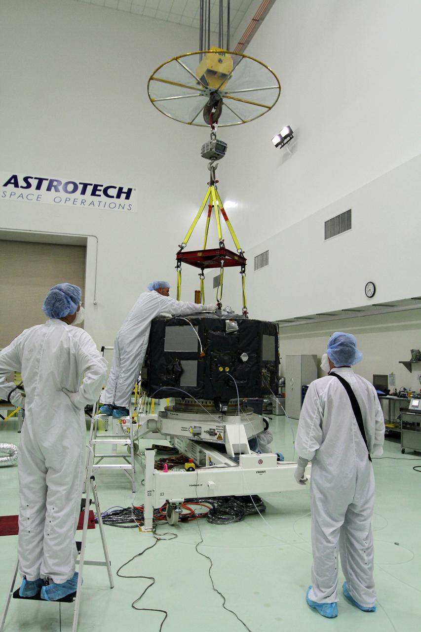 CAPE CANAVERAL, Fla. - Inside the Astrotech payload processing facility near NASA’s Kennedy Space Center in Florida, technicians prepare Radiation Belt Storm Probes, or RBSP, spacecraft A for a spin test. During the spin test, the spacecraft is turned at a rate of 55 rpm to ensure that it is properly balanced.    NASA’s RBSP mission will help us understand the sun’s influence on Earth and near-Earth space by studying the Earth’s radiation belts on various scales of space and time. RBSP will begin its mission of exploration of Earth’s Van Allen radiation belts and the extremes of space weather after its launch aboard a United Launch Alliance Atlas V rocket. Launch is targeted for Aug. 23. For more information, visit http://www.nasa.gov/rbsp. Photo credit: NASA/Charisse Nahser