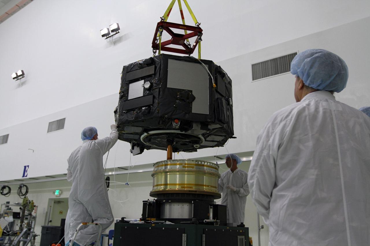 CAPE CANAVERAL, Fla. - Inside the Astrotech payload processing facility near NASA’s Kennedy Space Center in Florida, technicians prepare to place Radiation Belt Storm Probes, or RBSP, spacecraft A on a spin test stand. During the spin test, the spacecraft is turned at a rate of 55 rpm to ensure that it is properly balanced.    NASA’s RBSP mission will help us understand the sun’s influence on Earth and near-Earth space by studying the Earth’s radiation belts on various scales of space and time. RBSP will begin its mission of exploration of Earth’s Van Allen radiation belts and the extremes of space weather after its launch aboard a United Launch Alliance Atlas V rocket. Launch is targeted for Aug. 23. For more information, visit http://www.nasa.gov/rbsp. Photo credit: NASA/Charisse Nahser