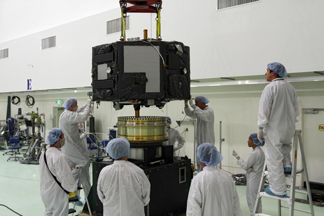 CAPE CANAVERAL, Fla. - Inside the Astrotech payload processing facility near NASA’s Kennedy Space Center in Florida, technicians prepare to place Radiation Belt Storm Probes, or RBSP, spacecraft A on a spin test stand. During the spin test, the spacecraft is turned at a rate of 55 rpm to ensure that it is properly balanced.    NASA’s RBSP mission will help us understand the sun’s influence on Earth and near-Earth space by studying the Earth’s radiation belts on various scales of space and time. RBSP will begin its mission of exploration of Earth’s Van Allen radiation belts and the extremes of space weather after its launch aboard a United Launch Alliance Atlas V rocket. Launch is targeted for Aug. 23. For more information, visit http://www.nasa.gov/rbsp. Photo credit: NASA/Charisse Nahser
