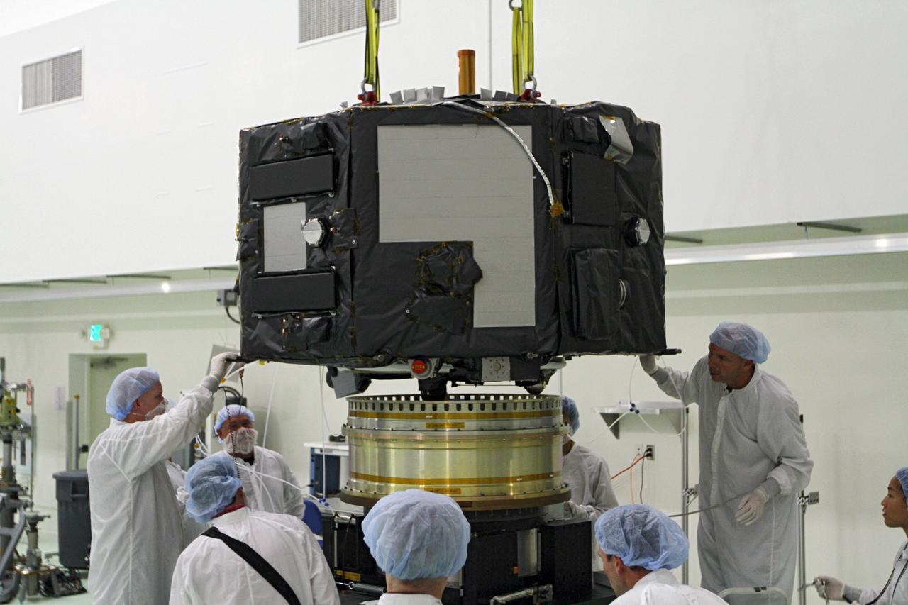 CAPE CANAVERAL, Fla. - Inside the Astrotech payload processing facility near NASA’s Kennedy Space Center in Florida, technicians prepare to place Radiation Belt Storm Probes, or RBSP, spacecraft A on a spin test stand. During the spin test, the spacecraft is turned at a rate of 55 rpm to ensure that it is properly balanced.    NASA’s RBSP mission will help us understand the sun’s influence on Earth and near-Earth space by studying the Earth’s radiation belts on various scales of space and time. RBSP will begin its mission of exploration of Earth’s Van Allen radiation belts and the extremes of space weather after its launch aboard a United Launch Alliance Atlas V rocket. Launch is targeted for Aug. 23. For more information, visit http://www.nasa.gov/rbsp. Photo credit: NASA/Charisse Nahser