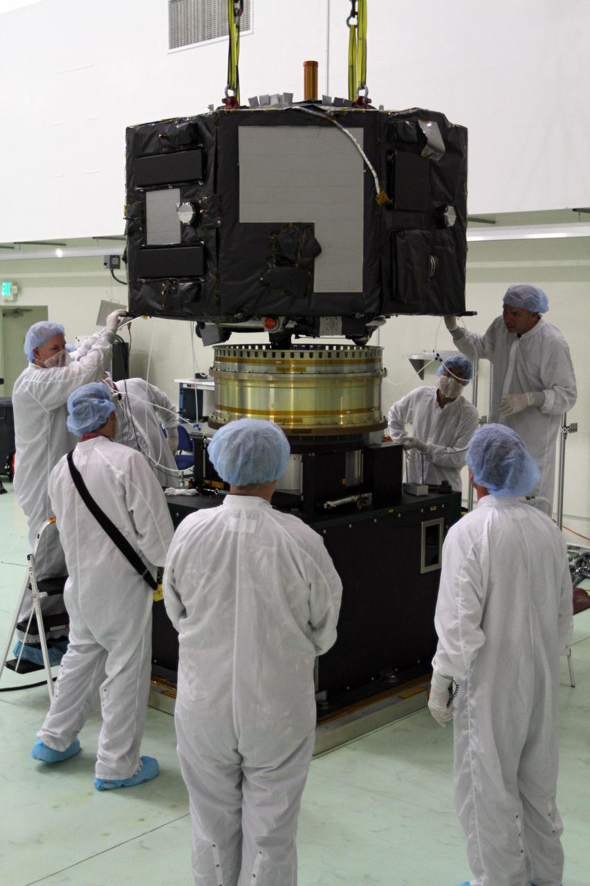 CAPE CANAVERAL, Fla. - Inside the Astrotech payload processing facility near NASA’s Kennedy Space Center in Florida, technicians lower Radiation Belt Storm Probes, or RBSP, spacecraft A onto a spin test stand. During the spin test, the spacecraft is turned at a rate of 55 rpm to ensure that it is properly balanced.    NASA’s RBSP mission will help us understand the sun’s influence on Earth and near-Earth space by studying the Earth’s radiation belts on various scales of space and time. RBSP will begin its mission of exploration of Earth’s Van Allen radiation belts and the extremes of space weather after its launch aboard a United Launch Alliance Atlas V rocket. Launch is targeted for Aug. 23. For more information, visit http://www.nasa.gov/rbsp. Photo credit: NASA/Charisse Nahser
