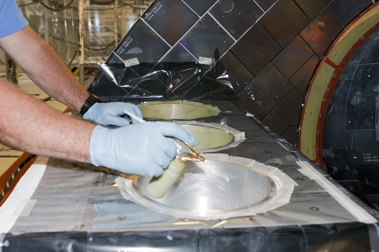 CAPE CANAVERAL, Fla. - In Orbiter Processing Facility Bay 2 at NASA’s Kennedy Space Center in Florida, a technician spray paints simulated thrusters on the space shuttle Endeavour.      The work is part of Transition and Retirement of the remaining space shuttles, Endeavour and Atlantis. Endeavour is being prepared for public display at the California Science Center in Los Angeles. Its ferry flight to California is targeted for mid-September. Endeavour was the last space shuttle added to NASA’s orbiter fleet. Over the course of its 19-year career, Endeavour spent 299 days in space during 25 missions. For more information, visit http://www.nasa.gov/transition Photo credit: NASA/Jim Grossmann