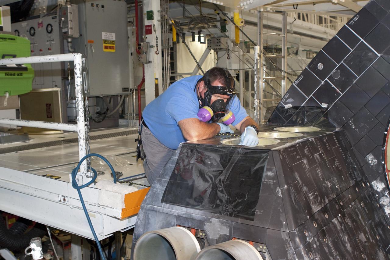 CAPE CANAVERAL, Fla. - In Orbiter Processing Facility Bay 2 at NASA’s Kennedy Space Center in Florida, United Space Alliance senior aerospace technician Alan Shinault spray paints simulated thrusters on the space shuttle Endeavour.      The work is part of Transition and Retirement of the remaining space shuttles, Endeavour and Atlantis. Endeavour is being prepared for public display at the California Science Center in Los Angeles. Its ferry flight to California is targeted for mid-September. Endeavour was the last space shuttle added to NASA’s orbiter fleet. Over the course of its 19-year career, Endeavour spent 299 days in space during 25 missions. For more information, visit http://www.nasa.gov/transition Photo credit: NASA/Jim Grossmann