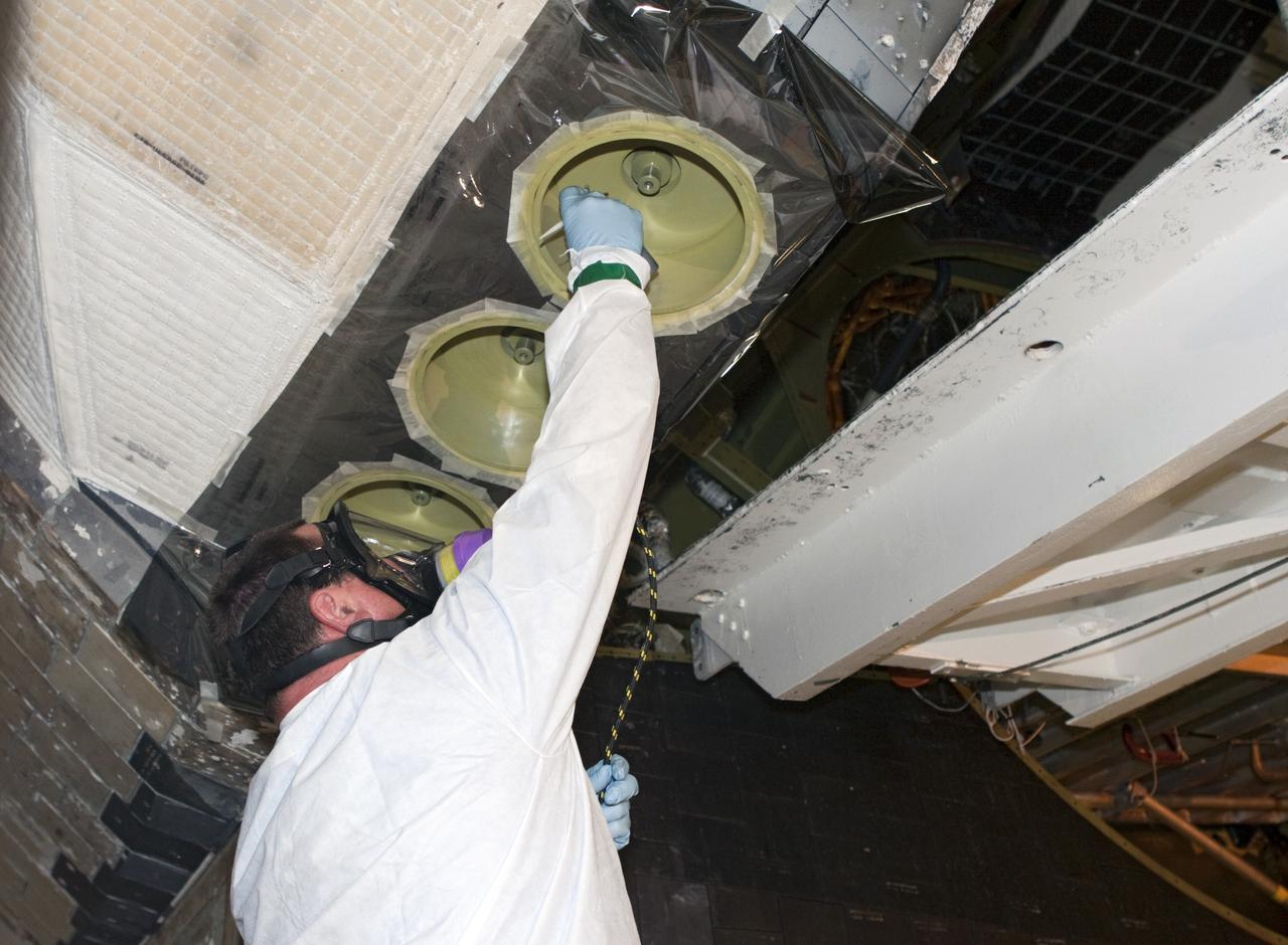 CAPE CANAVERAL, Fla. - In Orbiter Processing Facility Bay 2 at NASA’s Kennedy Space Center in Florida, United Space Alliance senior aerospace technician Alan Shinault spray paints simulated thrusters on the space shuttle Endeavour.     The work is part of Transition and Retirement of the remaining space shuttles, Endeavour and Atlantis. Endeavour is being prepared for public display at the California Science Center in Los Angeles. Its ferry flight to California is targeted for mid-September. Endeavour was the last space shuttle added to NASA’s orbiter fleet. Over the course of its 19-year career, Endeavour spent 299 days in space during 25 missions. For more information, visit http://www.nasa.gov/transition Photo credit: NASA/Jim Grossmann
