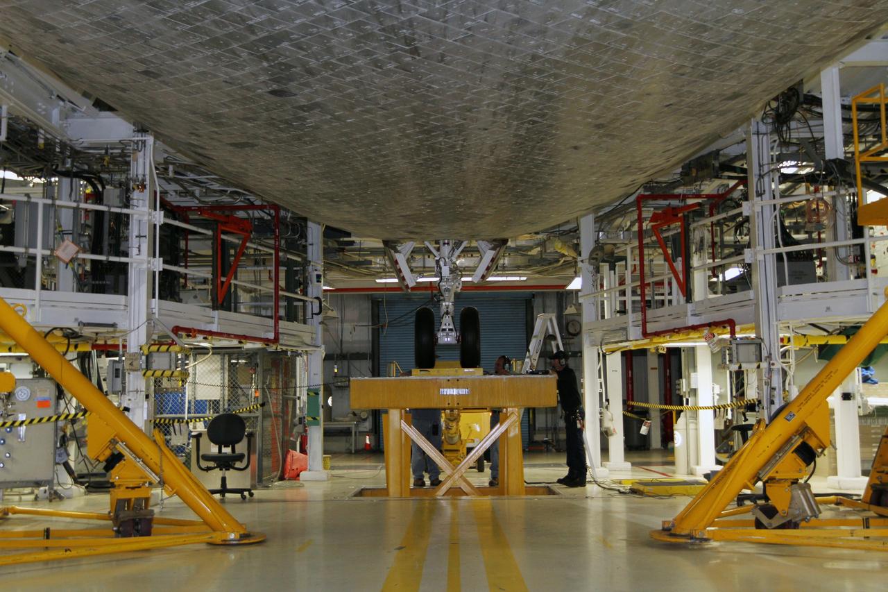 CAPE CANAVERAL, Fla. - Looking along the underbelly toward the nose landing gear of space shuttle Atlantis, technicians complete weight and center-of-gravity checks in Orbiter Processing Facility Bay 1 at NASA’s Kennedy Space Center in Florida.    The work is part of the Space Shuttle Program’s transition and retirement processing of the shuttle fleet. A groundbreaking was held Jan. 18, 2012, for Atlantis' future home, a 65,000-square-foot exhibit hall in Shuttle Plaza at the Kennedy Space Center Visitor Complex. Atlantis is scheduled to roll over to the visitor complex during November in preparation for the exhibit's grand opening in July 2013. For more information, visit http://www.nasa.gov/transition. Photo credit: NASA/Kim Shiflett