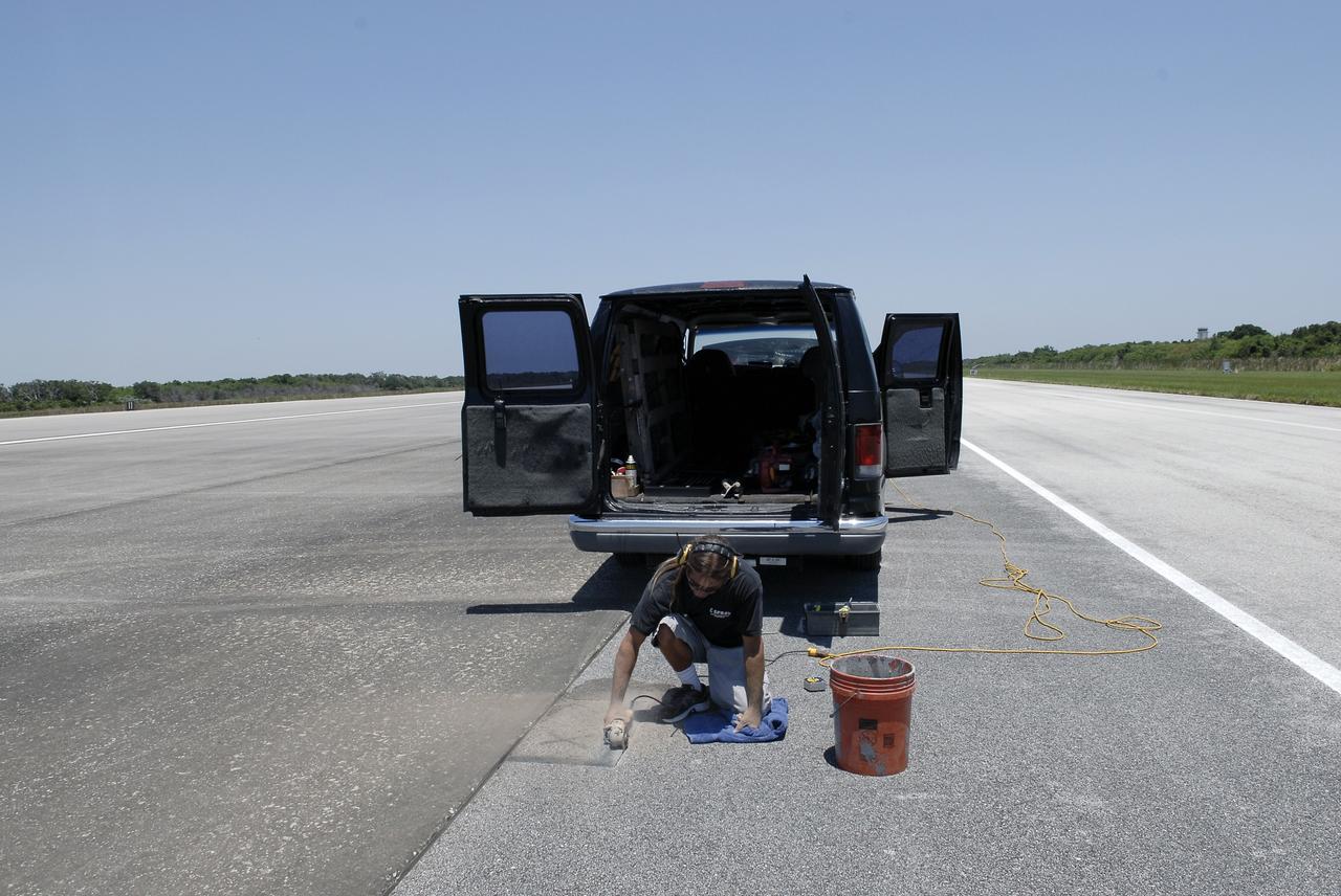 CAPE CANAVERAL, Fla. - At the Shuttle Landing Facility SLF at NASA’s Kennedy Space Center in Florida, Chad Stout with C Spray Glass Blasting in Cocoa, Fla., prepares to install a special plaque to mark the nose gear wheel stop of space shuttle Atlantis. Stout is cutting the 15,000 by 1,000-foot-long concrete runway to accommodate the black granite plaque, which is 16 by 28 inches. It is the third plaque permanently mounted to commemorate the final landing of each of the three orbiters. Atlantis completed the STS-135 mission by landing at the SLF on July 21, 2011, at 5:57 a.m. Atlantis flew 33 missions, completed 4,848 orbits of the Earth, traveled nearly 126 million miles and spent 307 days in space. Atlantis carried 207 astronauts to space. Photo credit: NASA/Charisse Nahser