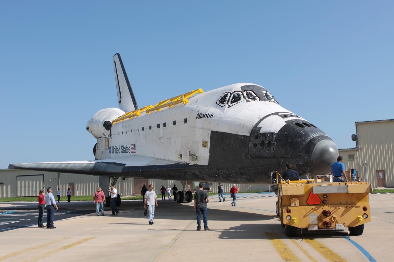 CAPE CANAVERAL, Fla. - Technicians monitor progress as space shuttle Atlantis is backed out of Orbiter Processing Facility Bay 1 for a move into High Bay 4 of the nearby Vehicle Assembly Building at NASA's Kennedy Space Center in Florida.    The work is part of the Space Shuttle Program's transition and retirement processing of the space shuttle fleet. A groundbreaking was held Jan. 18 for Atlantis' future home, a 65,000-square-foot exhibit hall in Shuttle Plaza at the Kennedy Space Center Visitor Complex. Atlantis is scheduled to roll over to the visitor complex in November in preparation for the exhibit's grand opening in July 2013. For more information, visit http://www.nasa.gov/transition. Photo credit: NASA/Jim Grossmann
